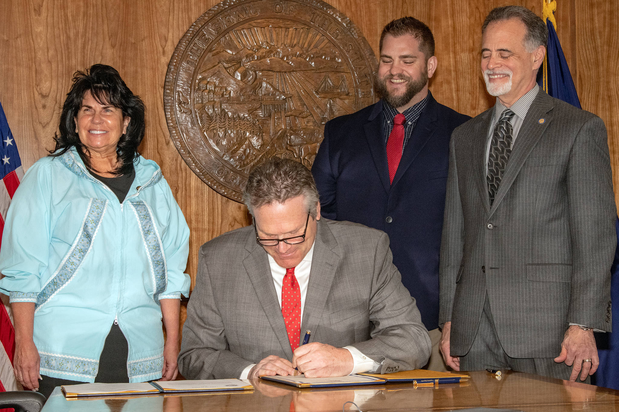 Gov. Mike Dunleavy (center) signs a proclamation ending the COVID-19 Emergency Declaration in the Alaska State Capitol on April 30, 2021. Dunleavy was joined by House Minority Leader Rep. Cathy Tilton, R-Wasilla (left) DHSS Commissioner Adam Crum(right), and Senate President Peter Micciche, R-Soldotna(far right). (Courtesy Photo / Office of Gov. Mike Dunleavy)
