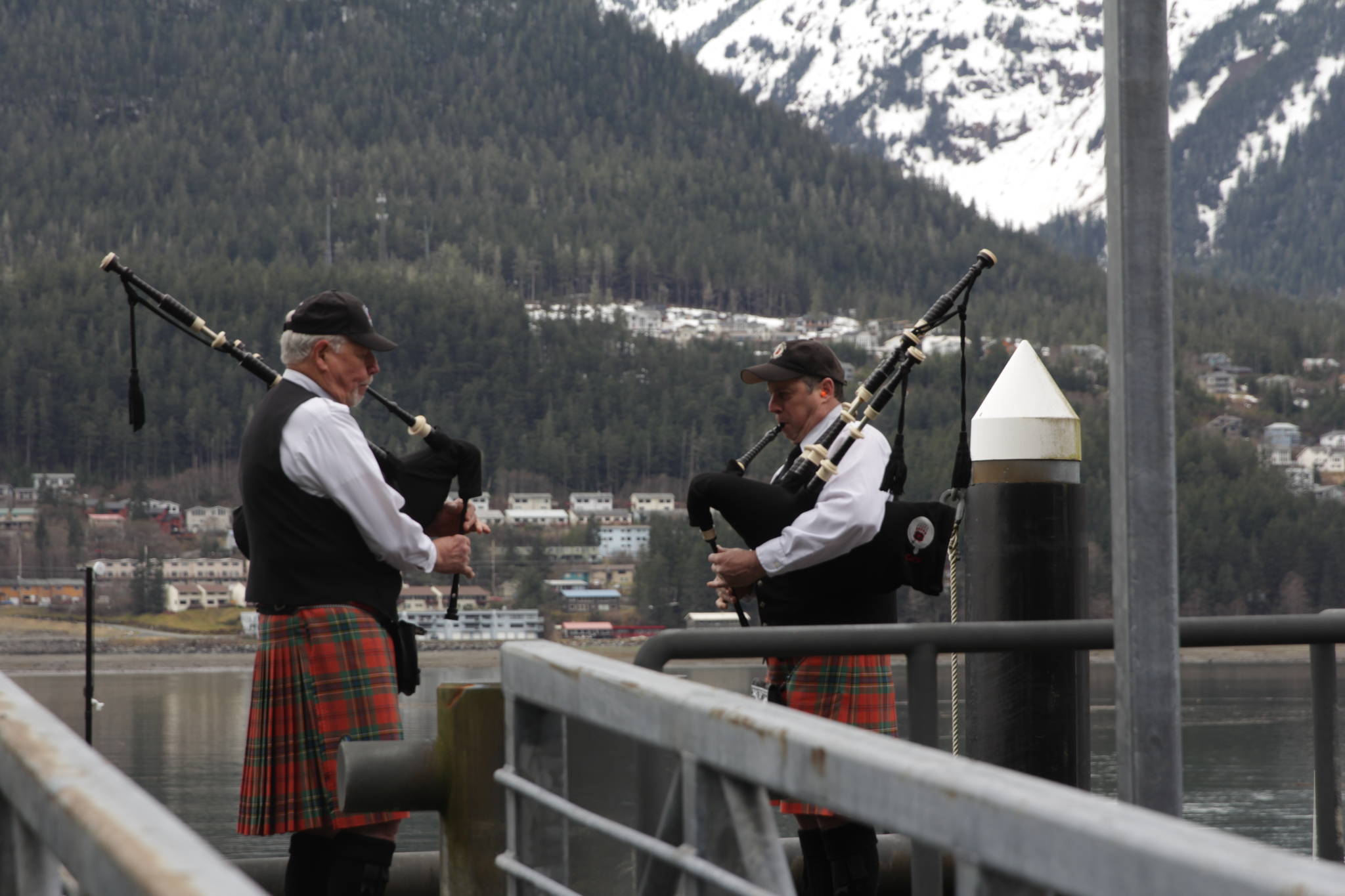 Members of the City of Juneau Pipe Band play their bagpipes during the 31st annual Blessing of the Fleet and Reading of Names at the Alaska Commercial Fishermen’s Memorial in Juneau on May 1, 2021. (Michael S. Lockett / Juneau Empire)