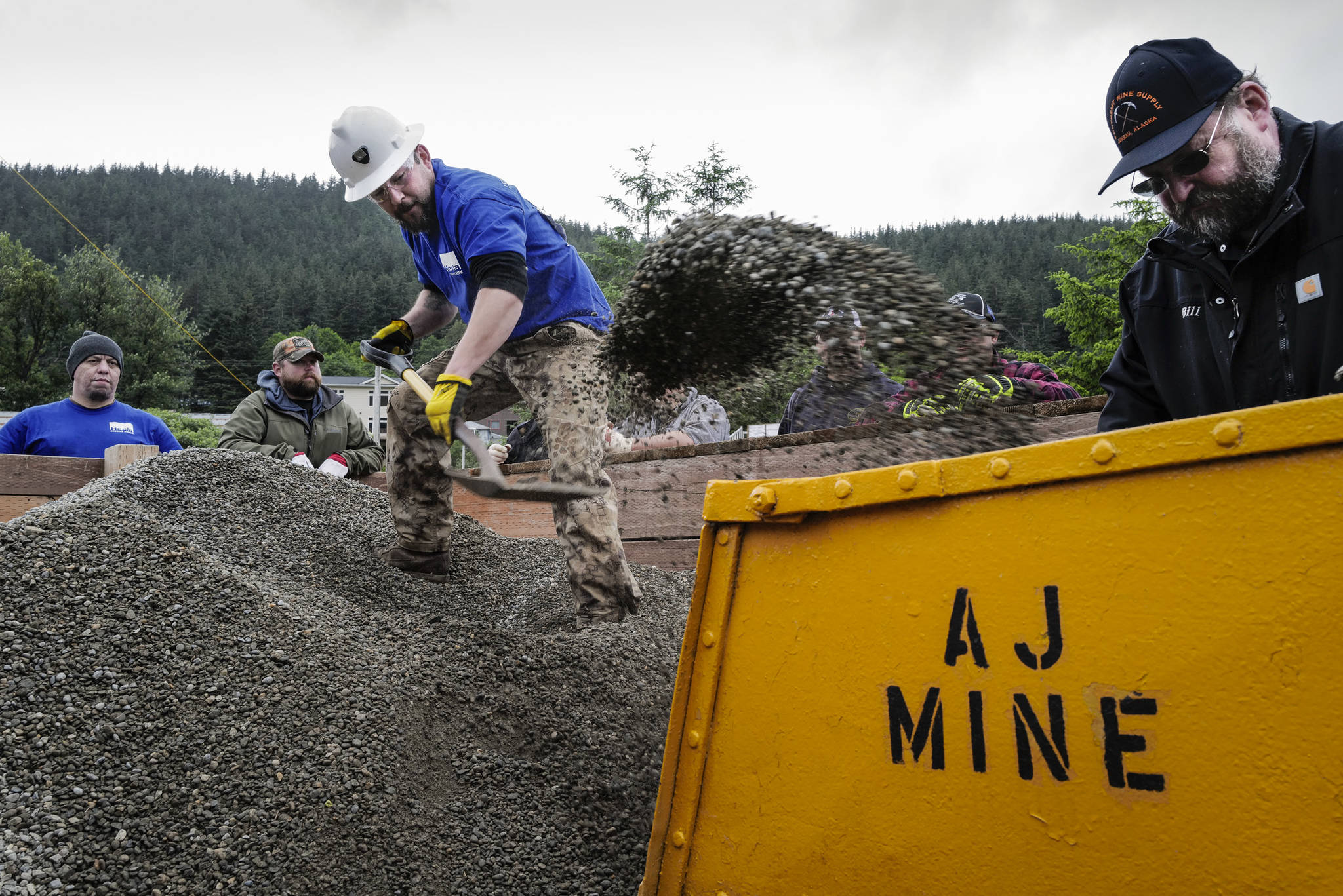 Heath Coro competes in the hand mucking contest as judge Bill Wilcox watches during the Mining & Logging Competition at the 29th Annual Gold Rush Days at Savikko Park on Saturday, June 22, 2019. The event has been canceled for 2021. (Michael Penn / Juneau Empire File)