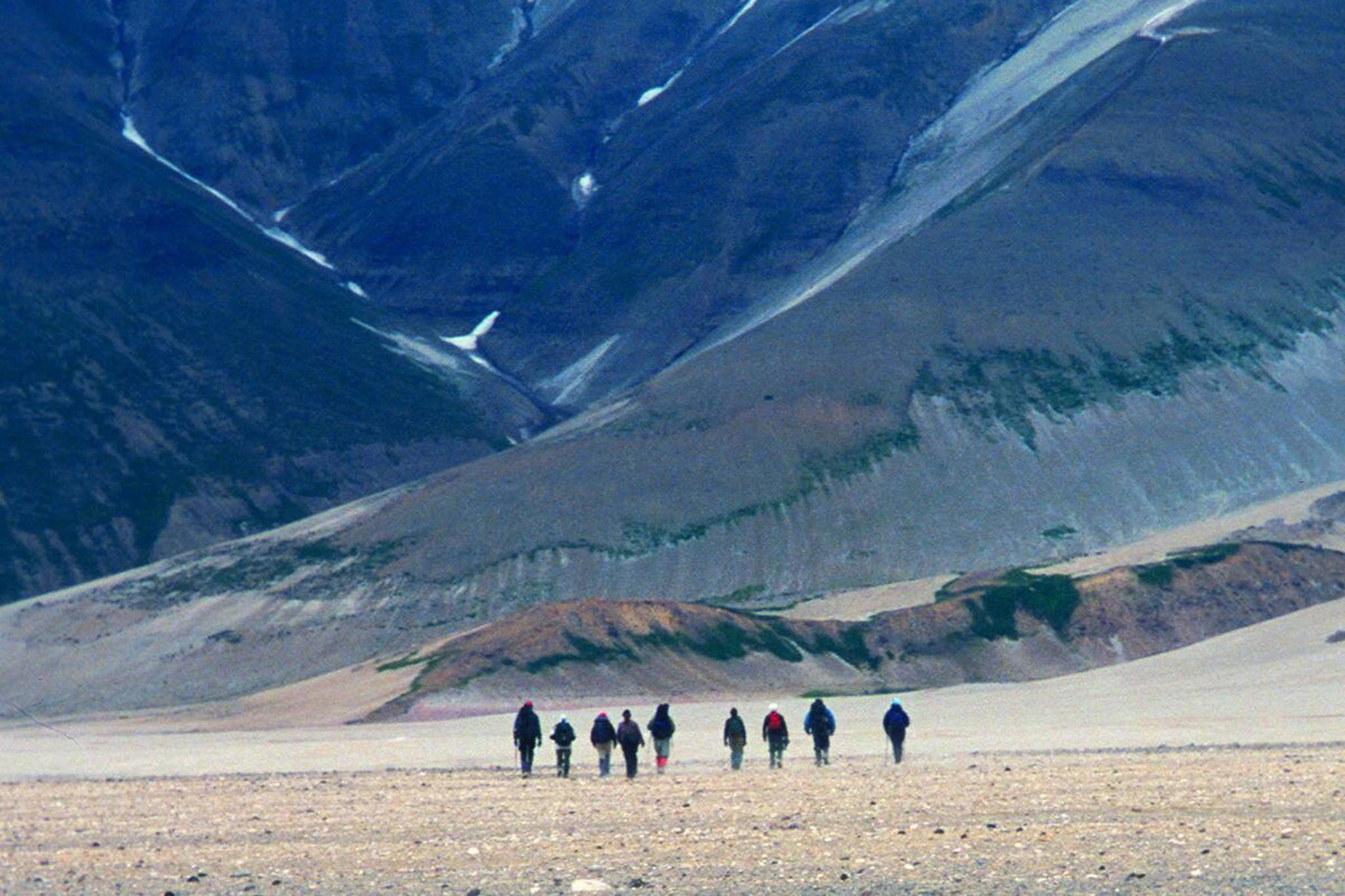 Hikers traverse the Valley of Ten Thousand Smokes on the Alaska Peninsula, walking on a sheet of ash and volcanic rock more than 500-feet thick. (Courtesy Photo / Ned Rozell)
