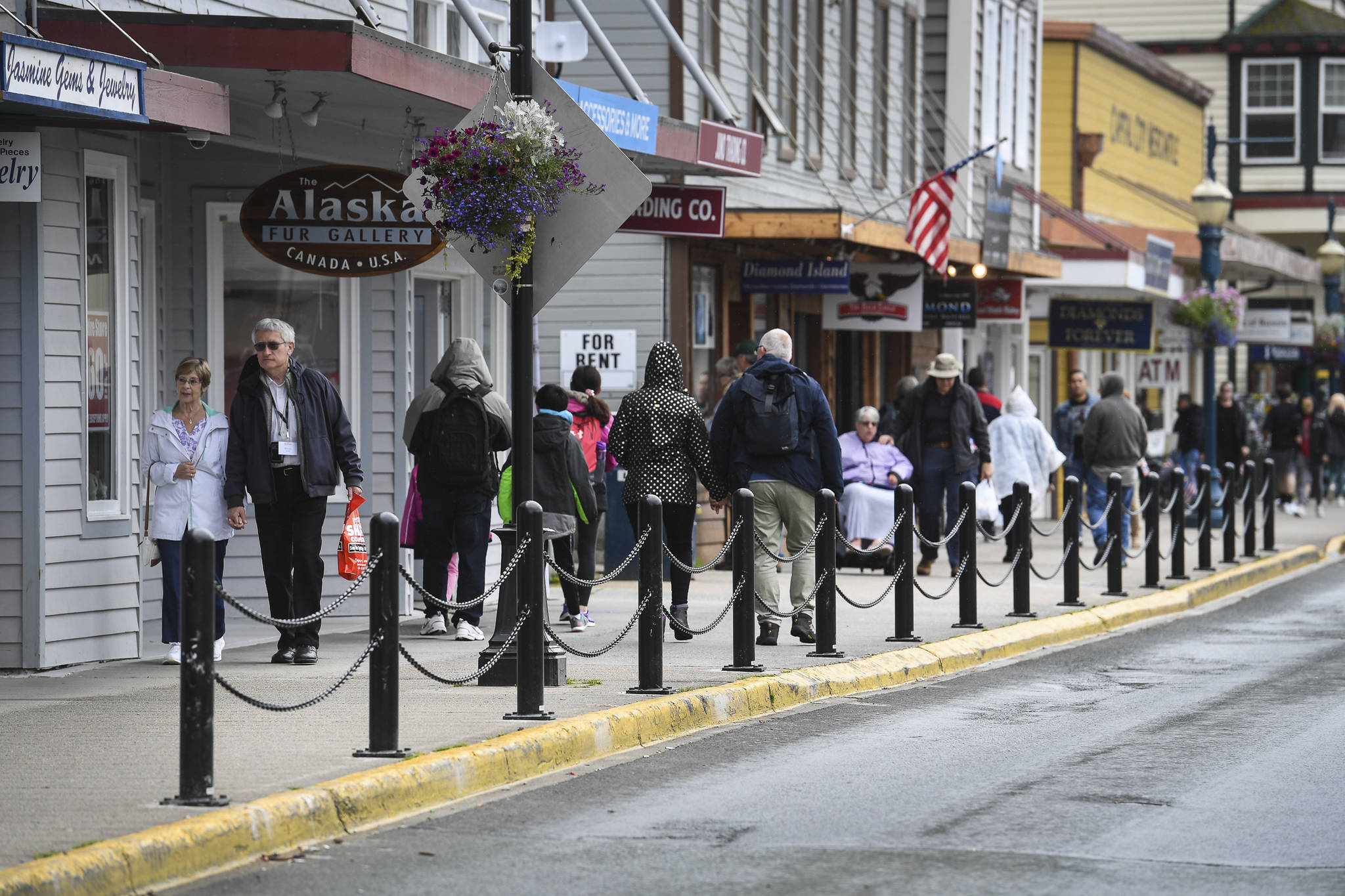 Pedestrians walk along South Franklin Street in July 2019. (Michael Penn / Juneau Empire File)