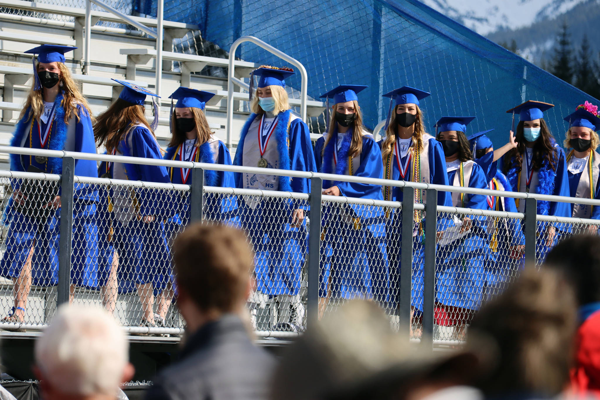 Members of the Thunder Mountain High School Class of 2021 file into the bleachers at Thunder Mountain High School. A distanced, masked and outdoor event was held at TMHS on Sunday. 
Ben Hohenstatt / Juneau Empire