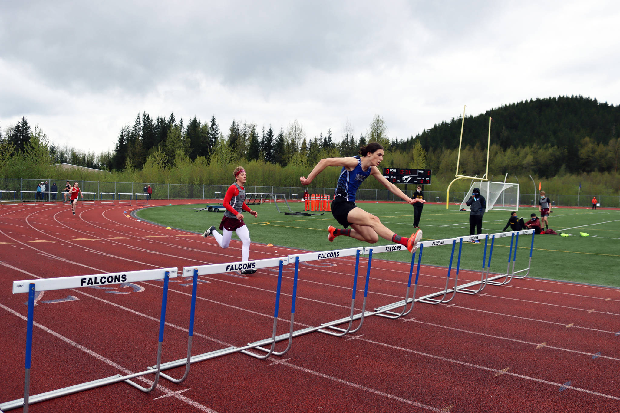 Eli Mead of Thunder Mountain High School jumps a hurdle during the Region V Track Meet at TMHS on Saturday, May 22. Mead finished first in the 300 hurdles for Region V, Division 1. (Ben Hohenstatt / Juneau Empire)