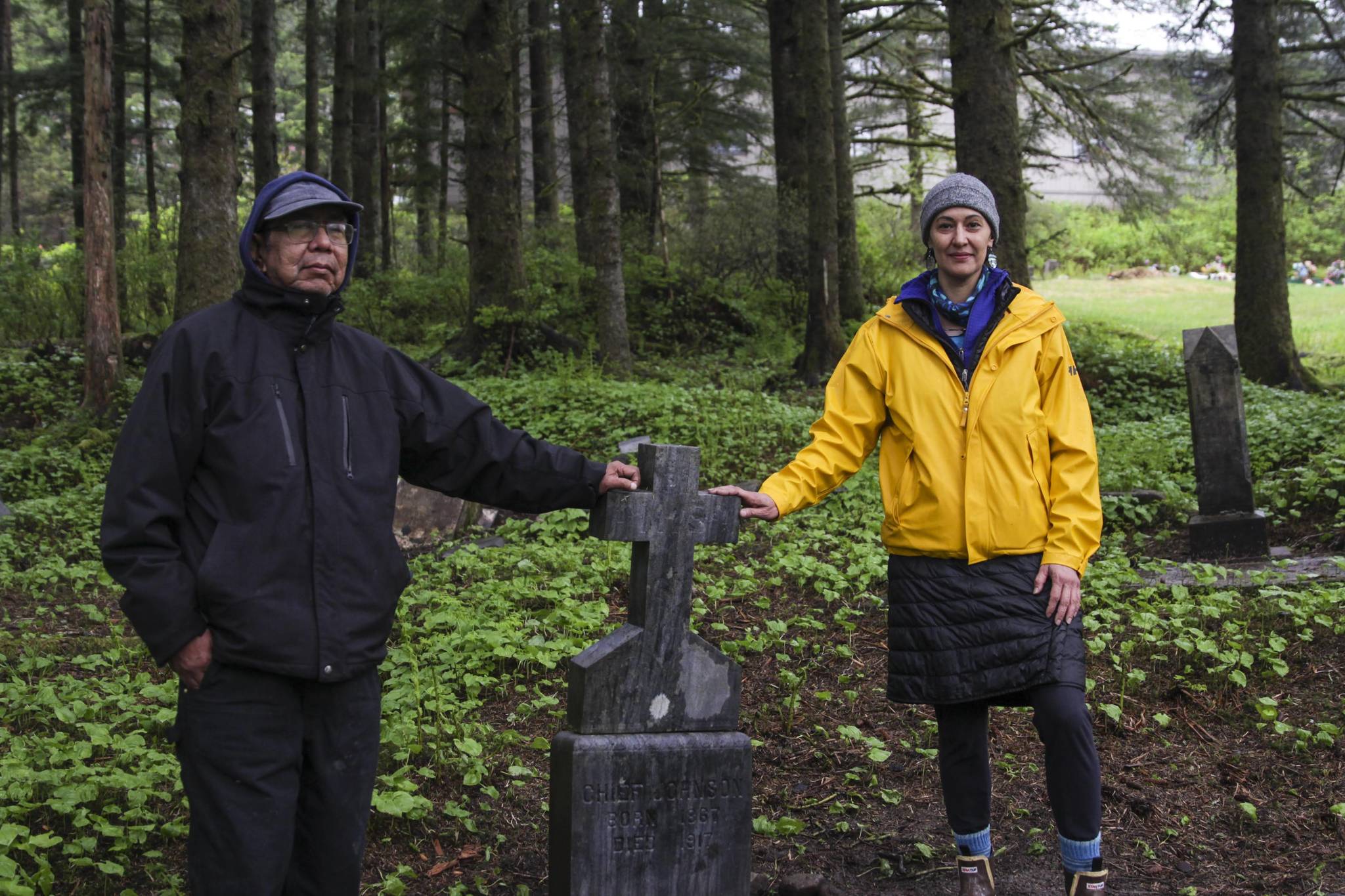 Bob Sam and Jamiann Hasselquist touch the headstone of Chief Joseph, a tribal leader buried in the Lawson Creek Cemetery in 1917, as they work with other volunteers to restore the cemetery, on May 22, 2021. (Michael S. Lockett / Juneau Empire)