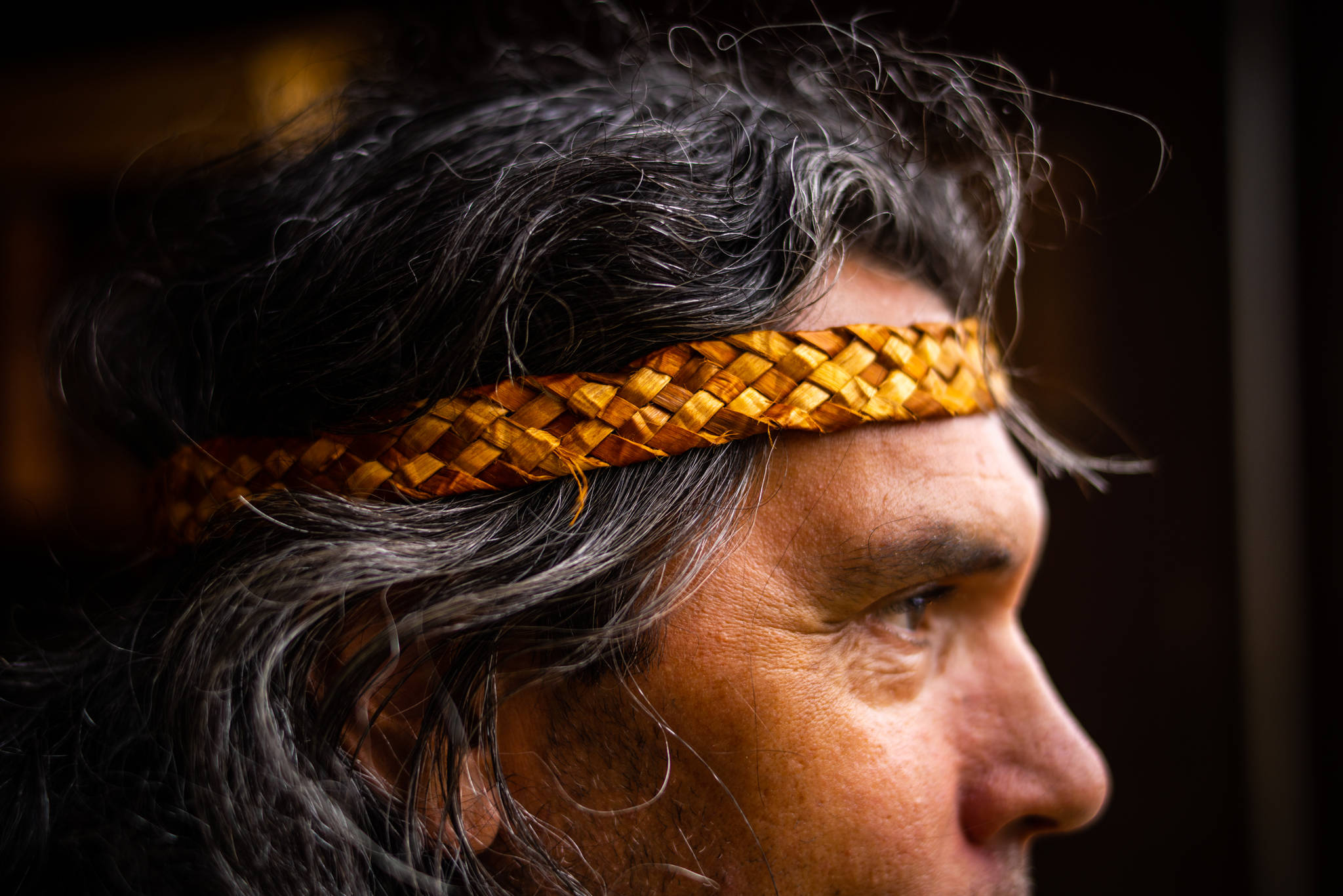 Michael Jones is a Kasaan artist and historical with the Organized Village of Kasaan. He wears a cedar headband he wove during the workshop. Jones is passionate about protecting and sharing the rich cultural history tied to the communities on Prince of Wales Island. (Courtesy Photo / Bethany Sonsini Goodrich)