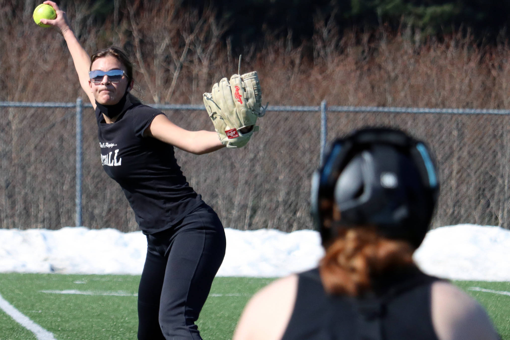 Avery Kreischer winds up to deliver a pitch to Sydney Strong during a mid-April practice at Thunder Mountain High School. TMHS will play host to the Region V Tournament in the coming days. (Ben Hohenstatt / Juneau Empire file)