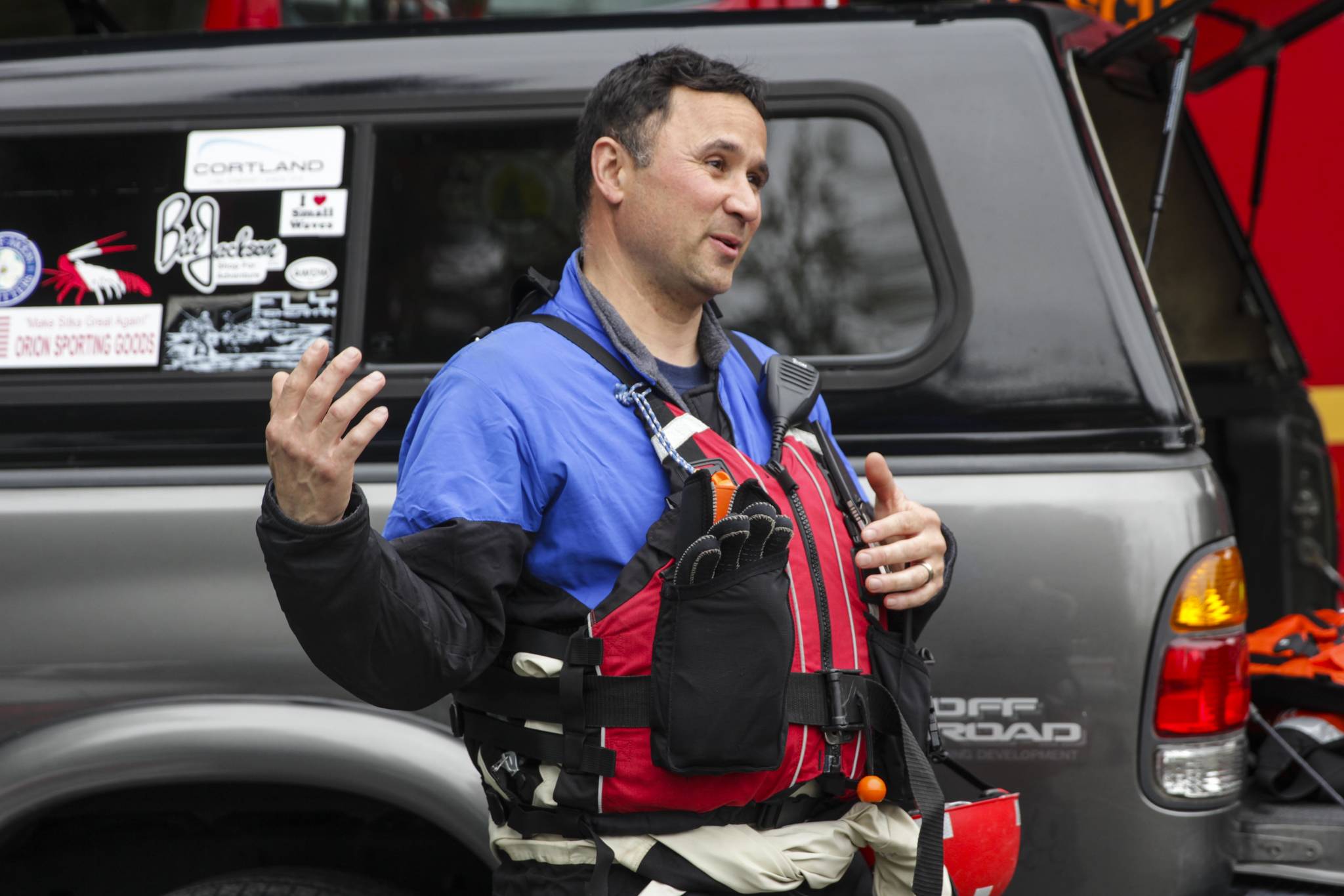 Capt. Jayme Johns, head of the Capital City Fire/Rescue’s water rescue team, briefs a group of CCFR personnel and Coast Guardsmen as they prepare to practice swiftwater rescues in the Mendenhall River on as National Boating Safety Week wraps up May 27, 2021. (Michael S. Lockett / Juneau Empire)