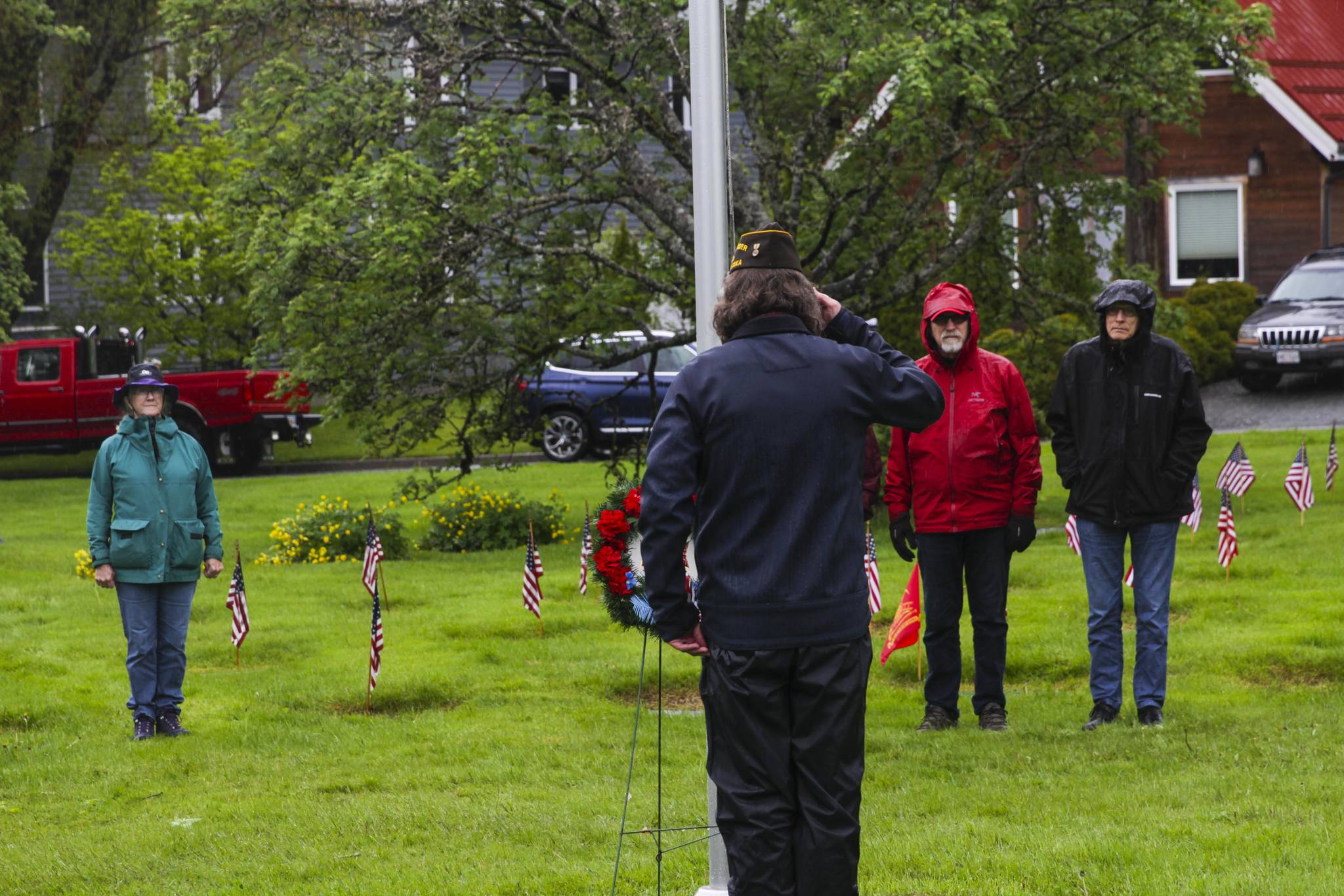 Veterans of Foreign Wars Post 5559 quartermaster Dan McCrummen salutes the wreath laid at the foot of the flagpole during a Memorial Day ceremony at Evergreen Cemetery on May 31, 2021. (Michael S. Lockett / Juneau Empire)