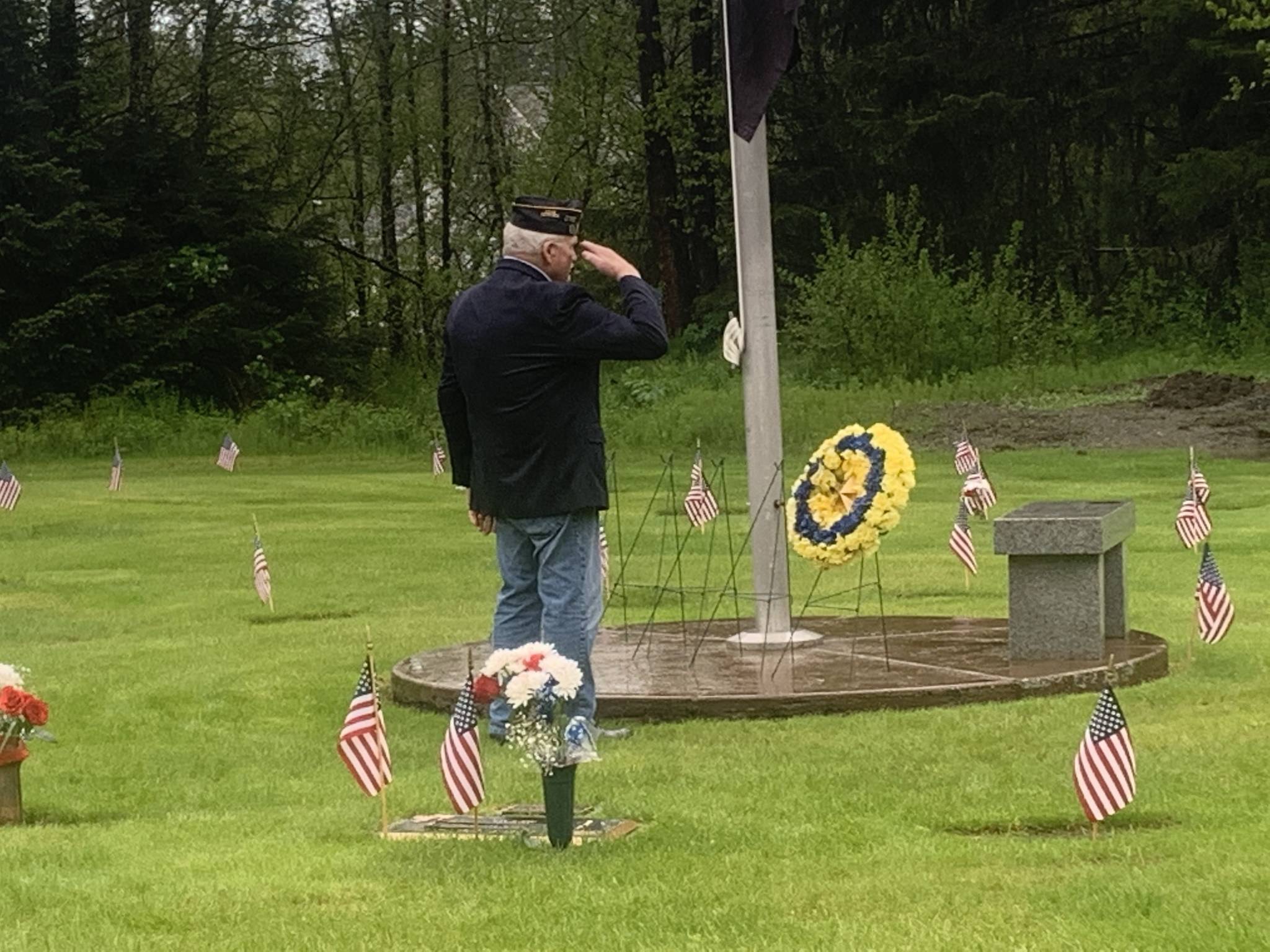 Dick Hand, a Coast Guard veteran, stands at salute after laying a wreath at Alaskan Memorial Park in remembrance of Americans who gave their lives for the country on Memorial Day, May 31, 2021. (Dana Zigmund / Juneau Empire)