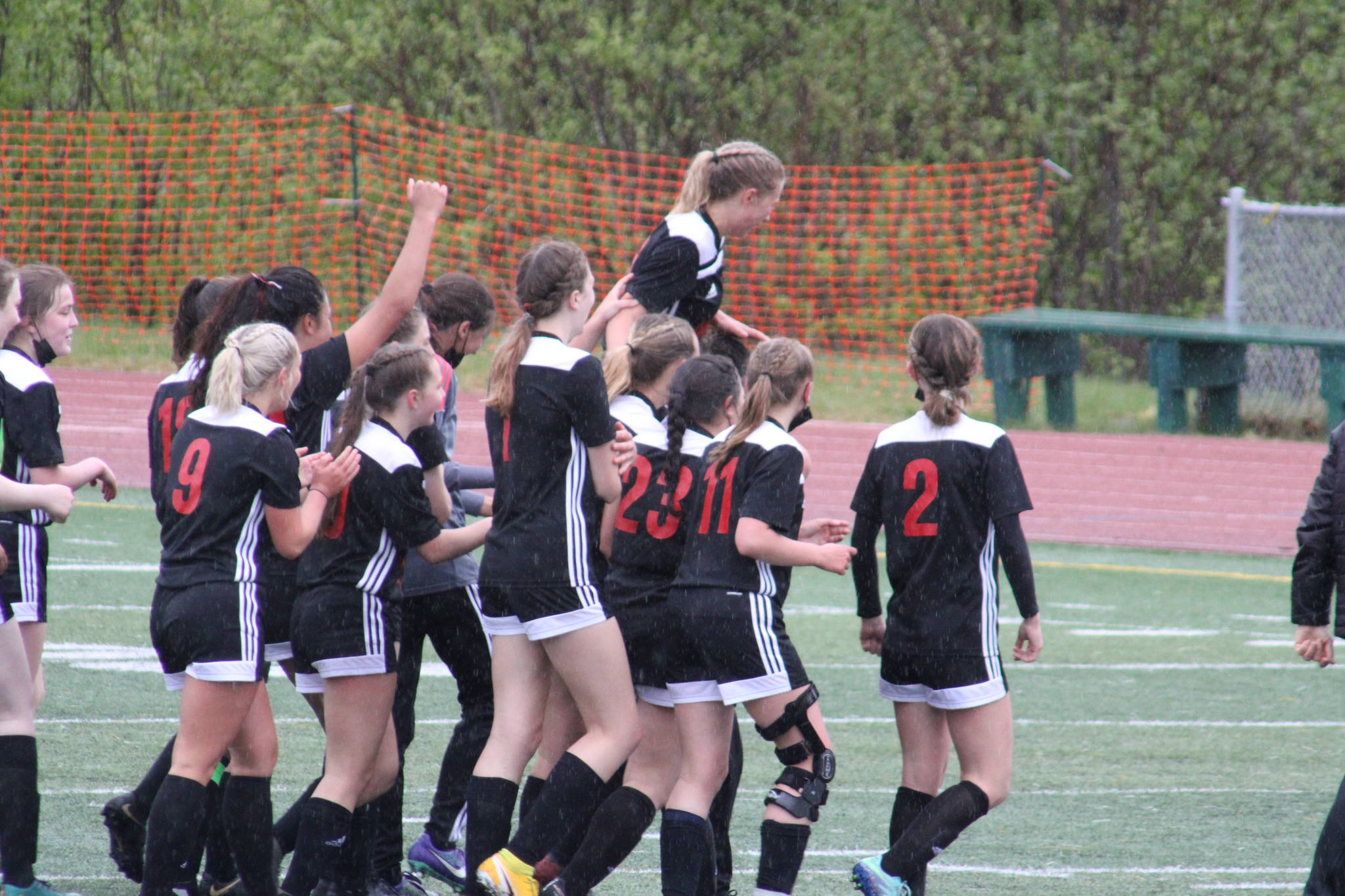 Members of the JDHS girls soccer team celebrate after clinching the state soccer title. The team capped a perfect season by besting the Soldotna Stars 5-1 to clinch the Division II title. (Courtesy Photo/Carolyn Kelley)