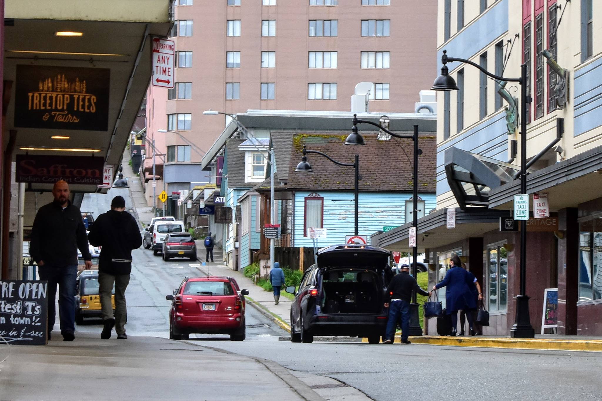 Visitors depart from the Baranoff Hotel in downtown Juneau on Thursday, June 3, 2021, just days after the typically year-round hotel reopened its doors after closing for the COVID-19 pandemic. Travelers are returning, hoteliers say, but many of their rooms remain empty. (Peter Segall / Juneau Empire)