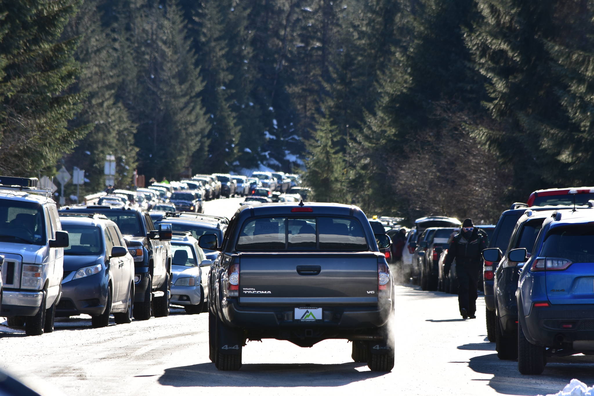 The parking lots at the Mendenhall Glacier Visitor Center were packed on Feb. 13, 2021, and plans to improve the facilities include expanding the parking lot. Those plans were criticized by residents for the impacts to the environment and a draft environmental impact statement is expected later this summer. (Peter Segall / Juneau Empire)