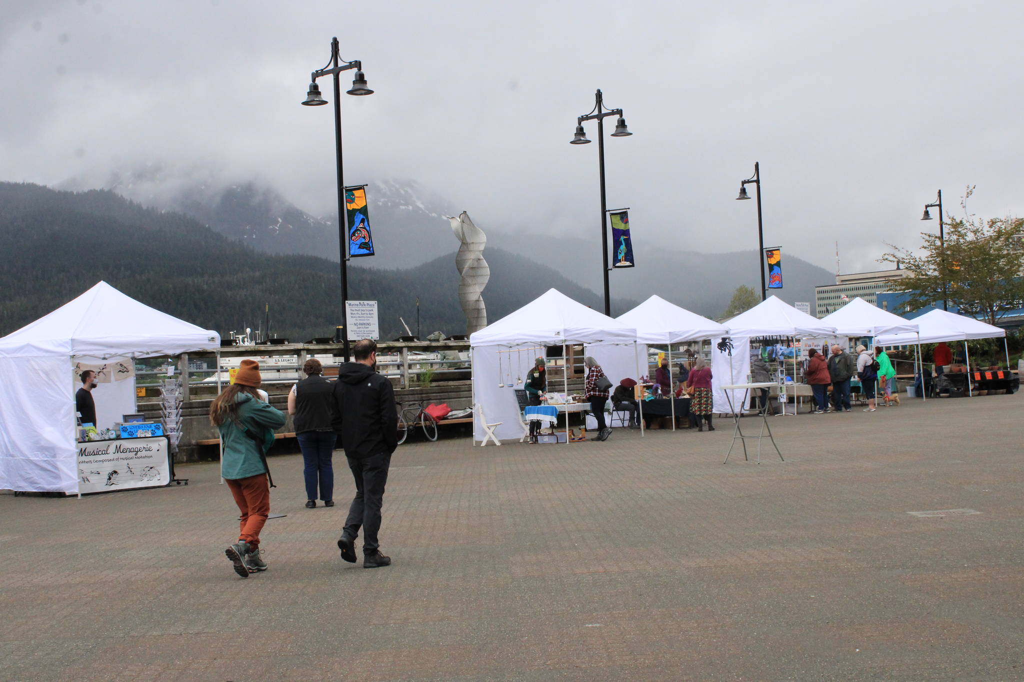 Shoppers strolled along the tents downtown on Saturday, June 5, checking out the wares of local artists. Across town, shoppers popped into a community-wide garage sale held at the Switzer Village Recreation Hall to benefit the Helping Hands Food Bank. (Dana Zigmund/Juneau Empire)