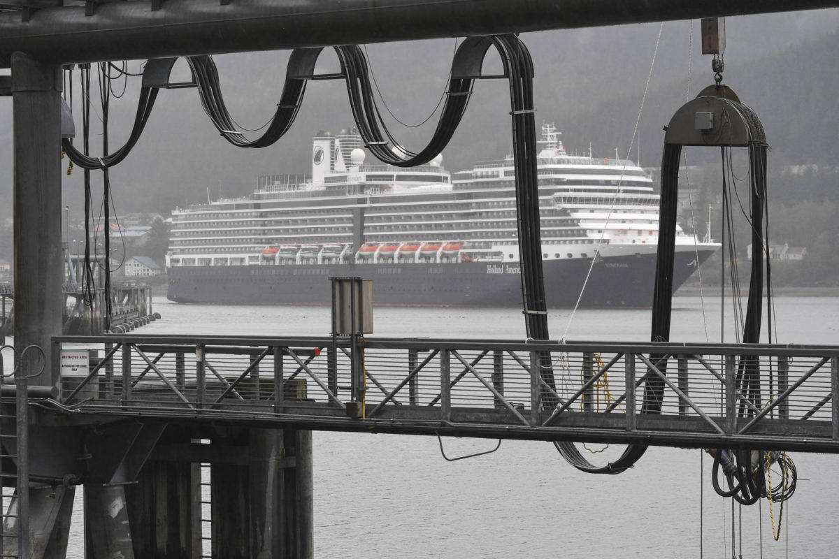 The Holland America Line Eurodam pulls into Juneau’s downtown harbor heading for the city-owned dock on Monday, May 6, 2019. The privately owned South Franklin Dock, foreground, is currently the only dock set up to provide electric power to a ship while at berth in Juneau. (Michael Penn | Juneau Empire File)