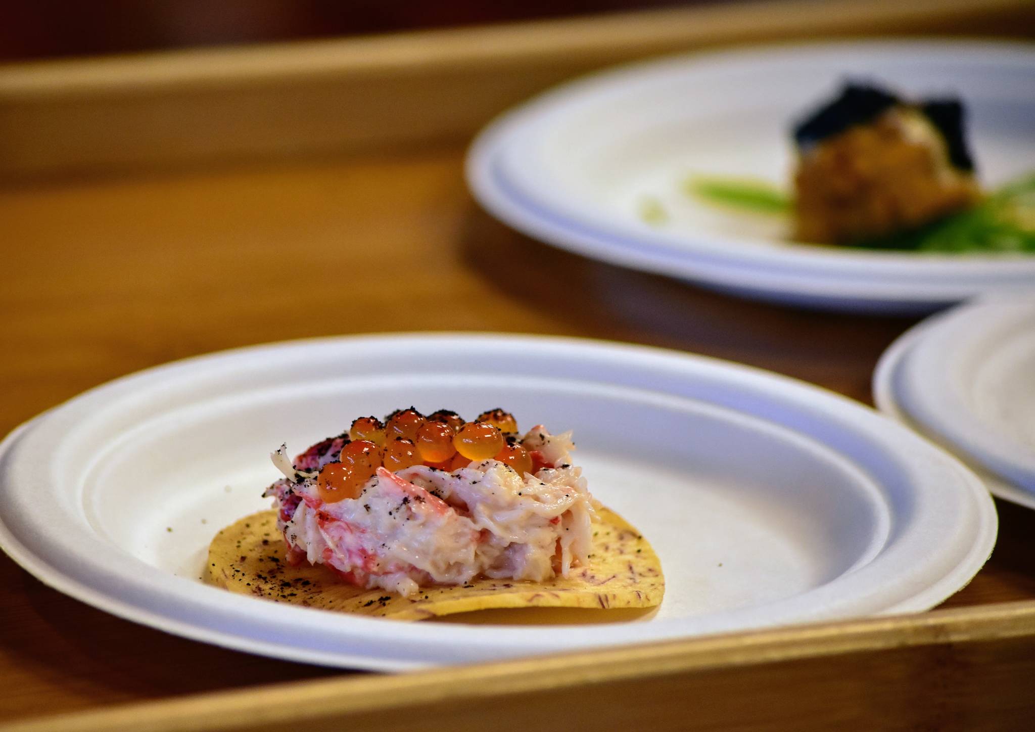 Alaskan king crab with seaweed, vanilla, salmon roe, crispy taro chip served at a charity dinner highlighting Alaska and Louisiana seafood at Forbbiden Peak Brewery on Tuesday, June 8, 2021. (Peter Segall / Juneau Empire)