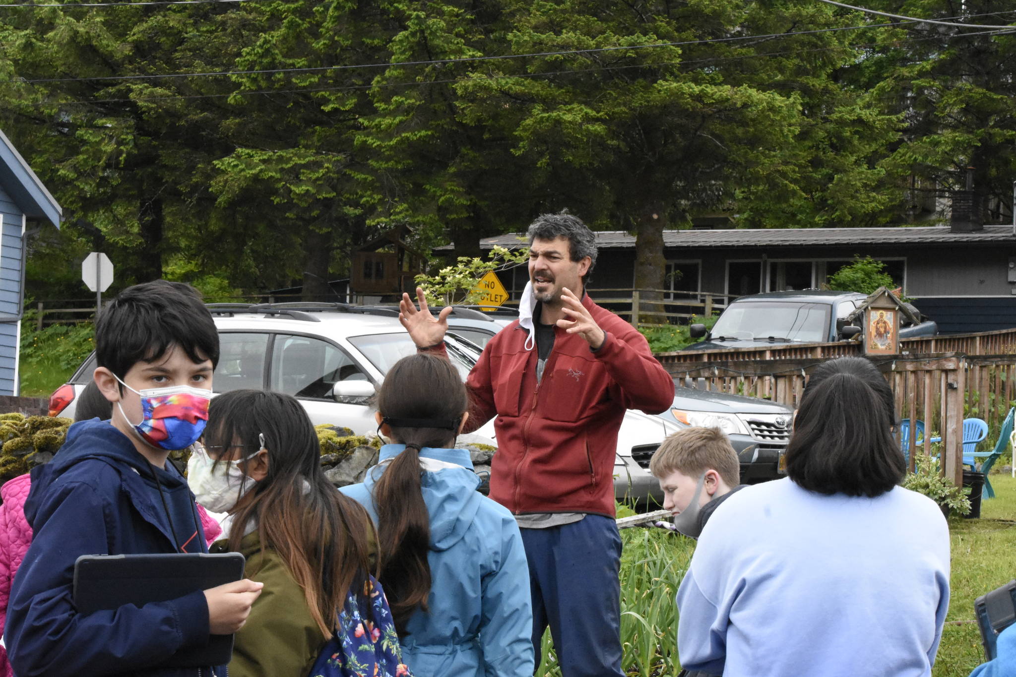 Peter Segall / Juneau Empire
Darren Snyder, who helps manage community gardens as part of the the University of Alaska Fairbanks Cooperative Extension Service, talks to kids about gardening in Southeast Alaska on June 11, 2021.