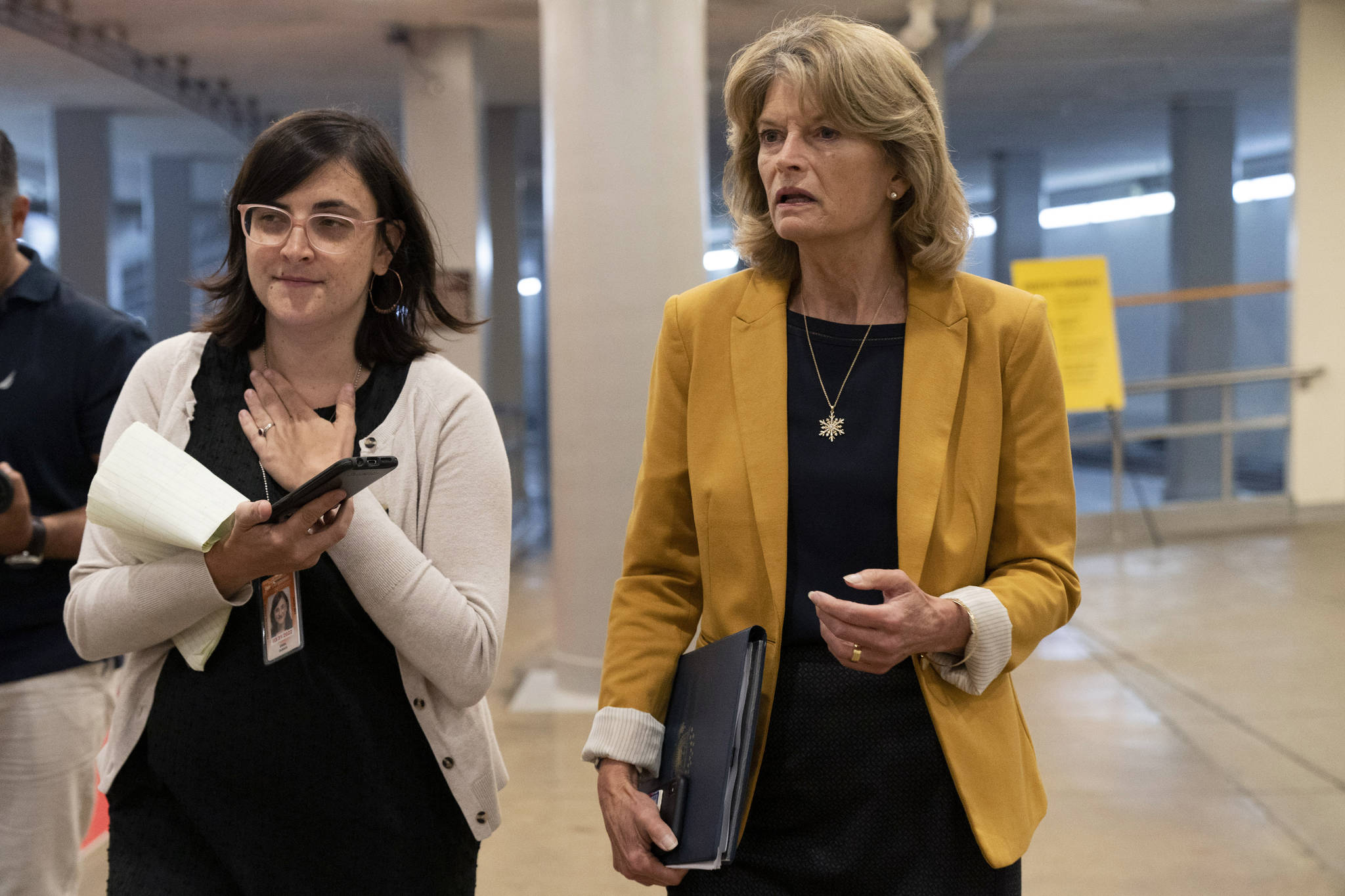 Sen. Lisa Murkowski, R-Alaska, right, speaks with a reporter while arriving for a Senate vote, Wednesday, June 16, 2021, on Capitol Hill in Washington. (AP Photo/Jacquelyn Martin)