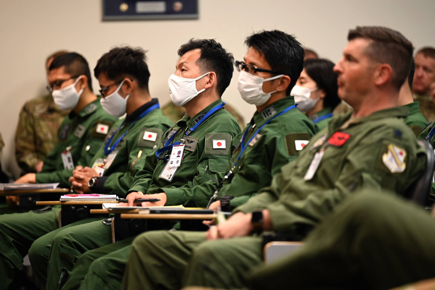 Service members from U.S. Air Force and Japan Air Self-Defense Force listen to the Deployed Forces Commander, Col. Brian Cusson, to kick-off RED FLAG-Alaska 21-2 at Joint Base Elmendorf-Richardson, Alaska, June 10, 2021. (Sheila deVera / U.S. Air Force)