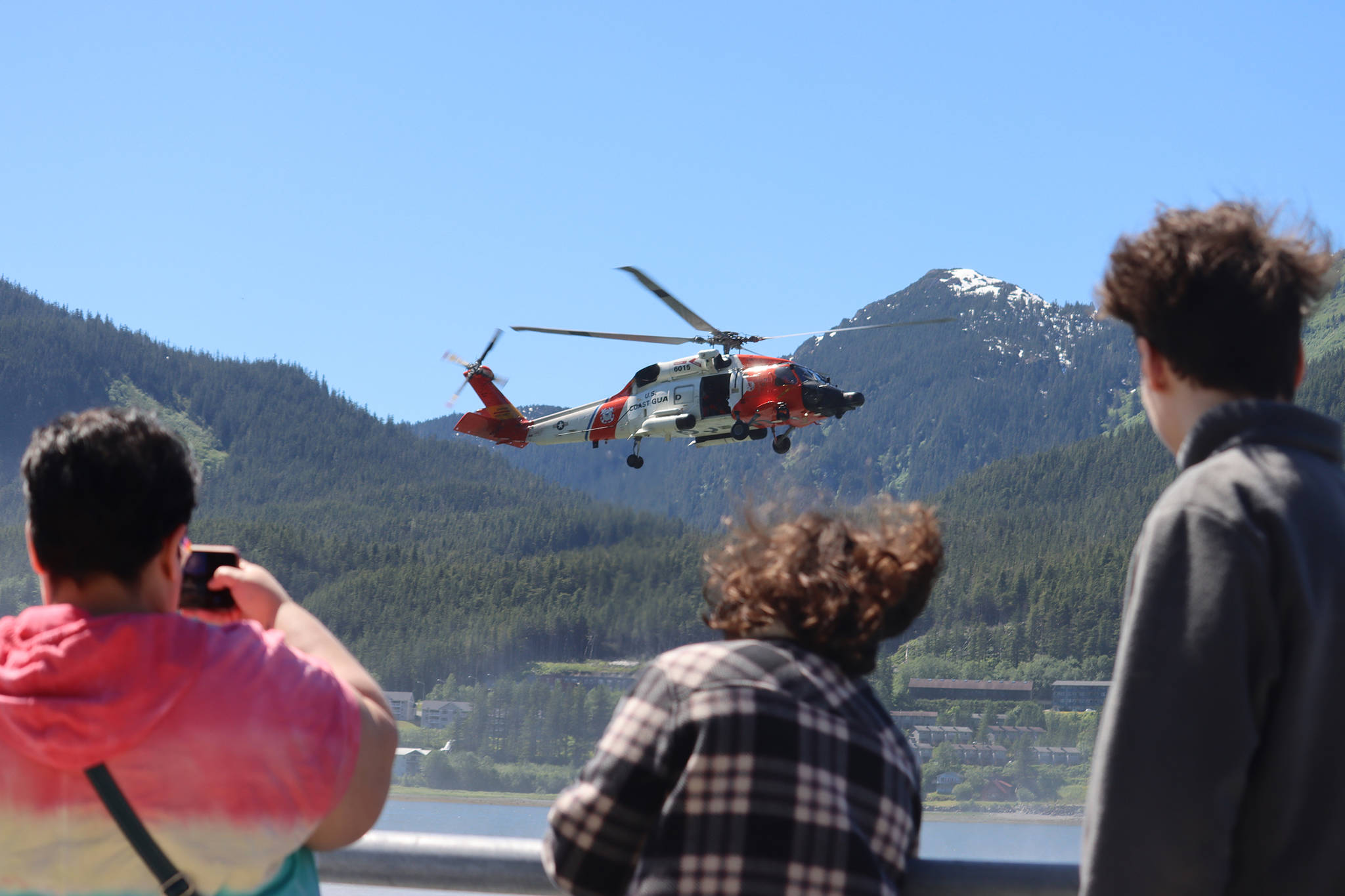 Onlookers watch a U.S. Coast Guard rescue demonstration Saturday in the Gastineau Channel during the 11th Juneau Maritime Festival. The event attracted thousands of people to Juneau for one of the first large, in-person events to be held in the capital city since the pandemic. (Ben Hohenstatt / Juneau Empire)