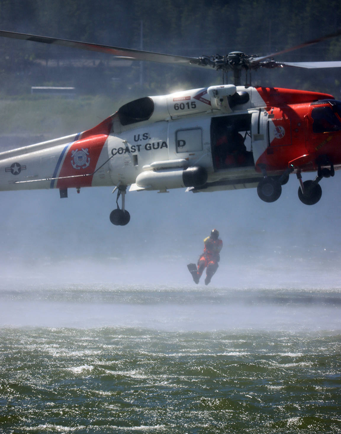 The U.S. Coast Guard demonstrated a water rescue in the Gastineau Channel during the 11th edition of the Juneau Maritime Festival. However, before a person could be retrieved from the water, they had to make a splashy entrance. (Ben Hohenstatt / Juneau Empire)
