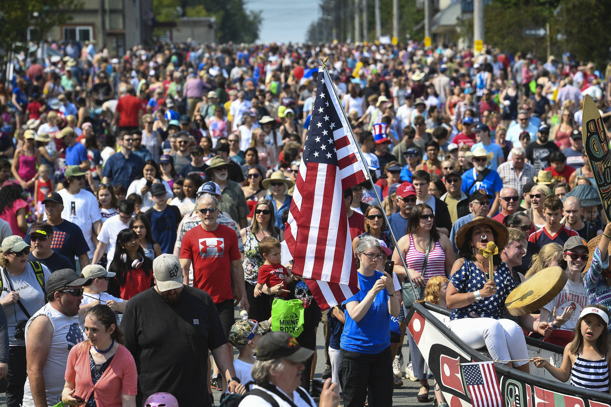 People follow the One People’s Canoe Society canoe to Savikko Park at the end of the Douglas Fourth of July Parade on Thursday, July 4, 2019. After the pandemic forced a hiatus on festivities last year, a full slate of activities are scheduled for this weekend. (Michael Penn/Juneau Empire File)