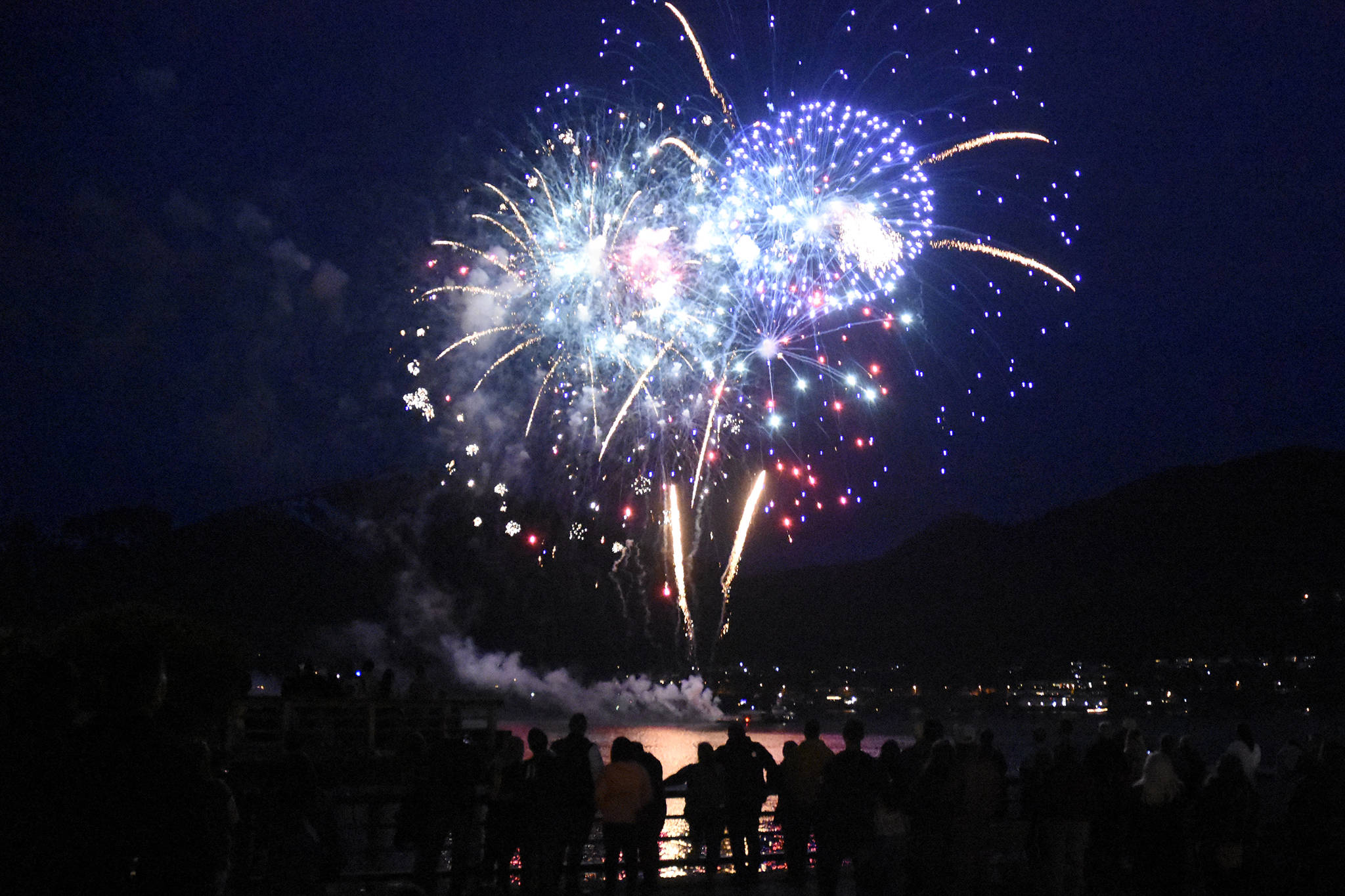 Fireworks light up the night sky over the Gastineau Channel with reds, whites and blues in the early hours of the Fourth of July. (Peter Segall / Juneau Empire)