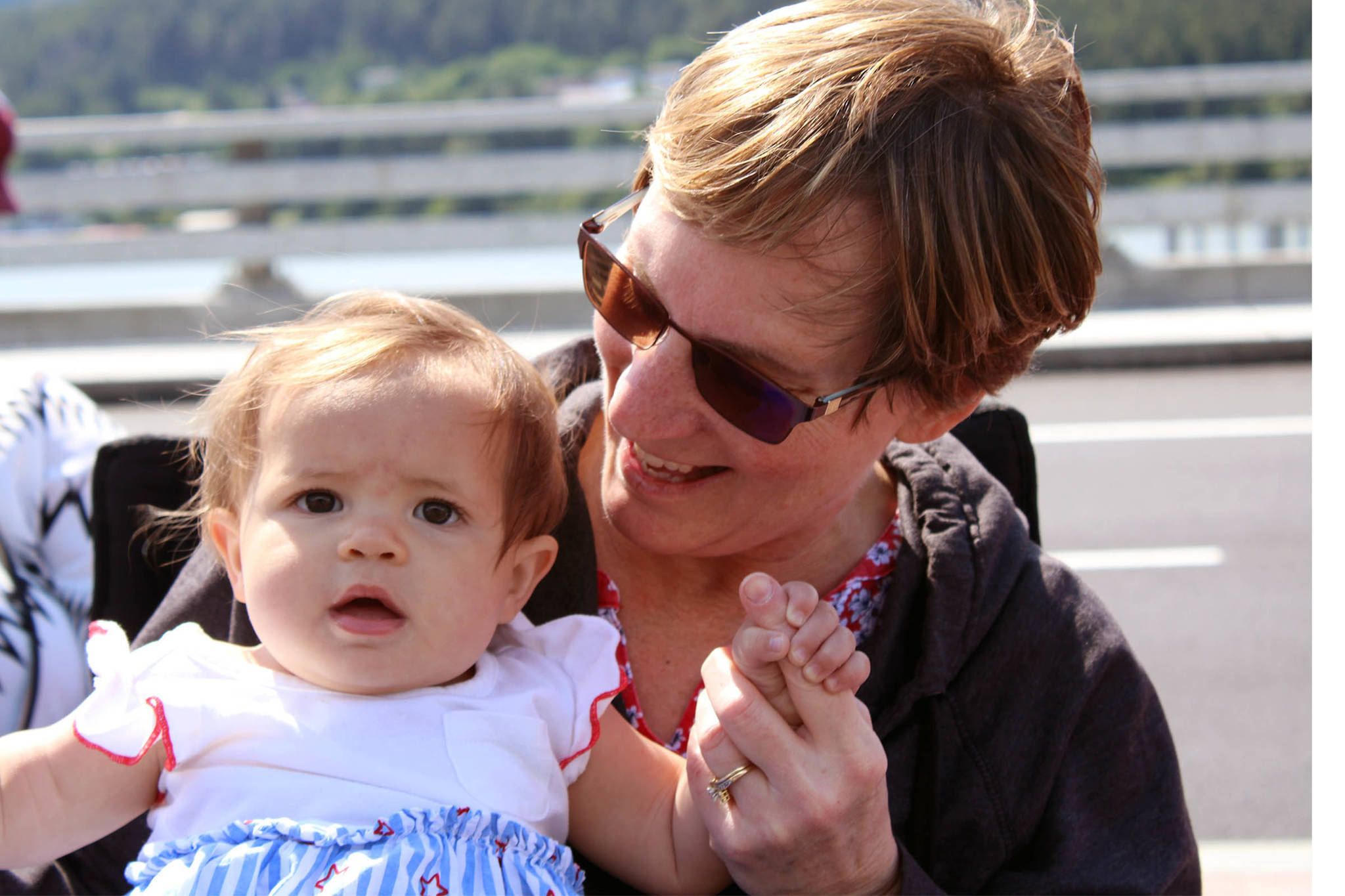 Millie Hiebenthal, 10 months, waits for the parade to start in downtown Juneau with her grandmother, Debbie Soto on Sunday. (Dana Zigmund/Juneau Empire)