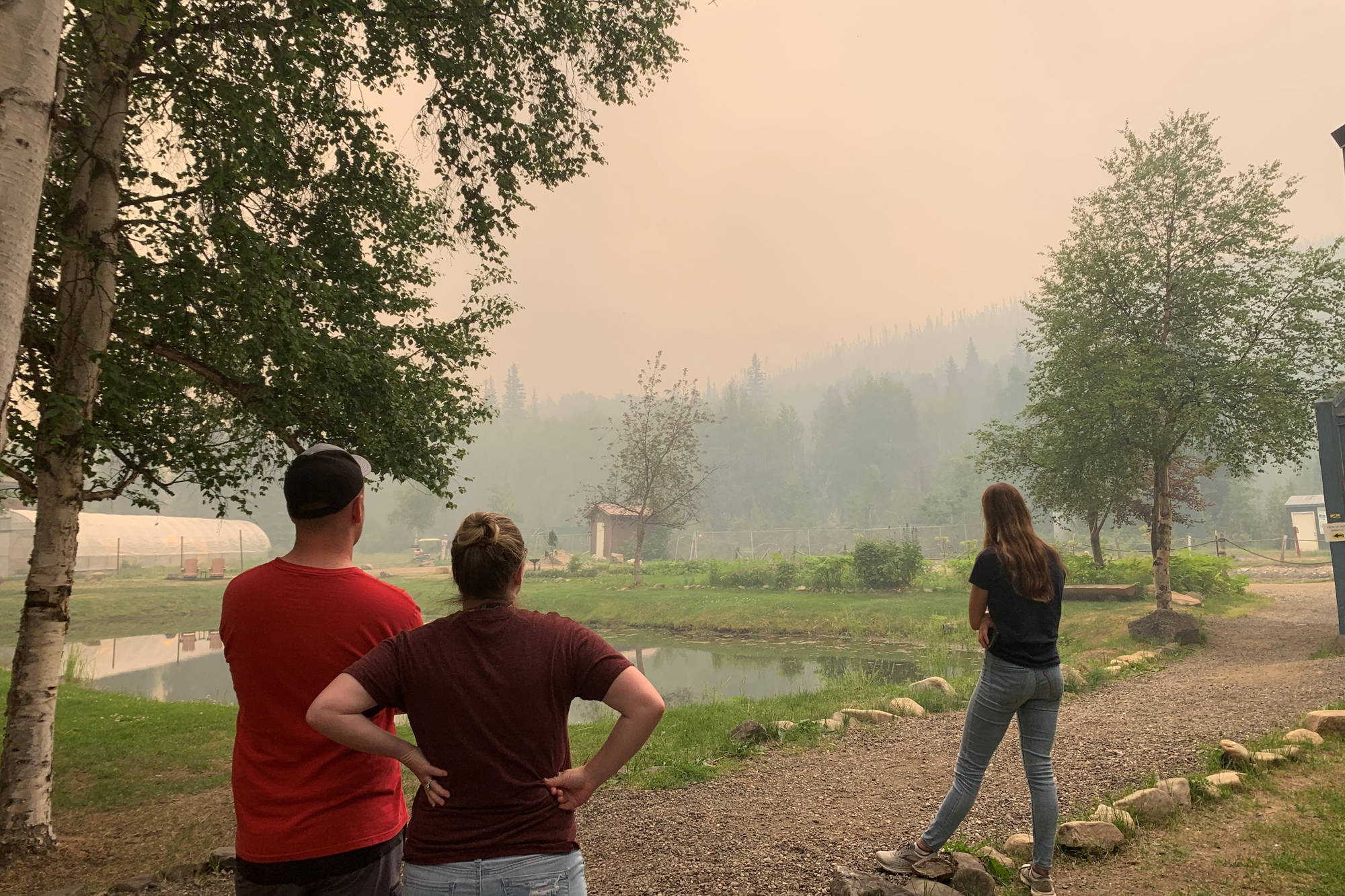 In this photo provided by the Alaska Division of Forestry, guests at the Chena Hot Springs Resort watch the Munson Creek Fire near Fairbanks, Alaska, on Monday, July 5, 2021. Authorities on Monday advised residents and guests at an Alaska hot springs resort to evacuate immediately after a nearby wildfire intensified. The Fairbanks North Star Borough issued the evacuation order when the fire reached a point less than a mile behind Chena Hot Springs. (Courtesy Photo / Alaska Division of Forestry)