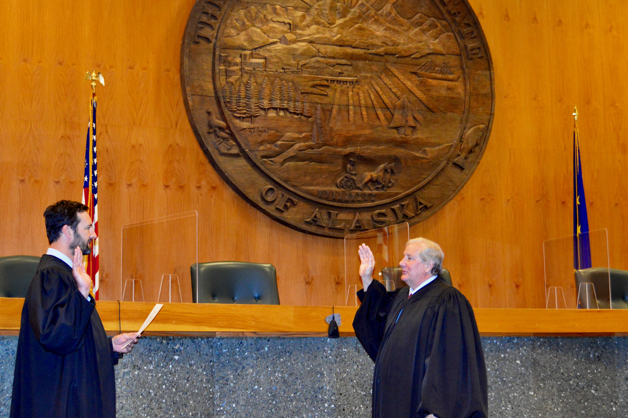 Chief Justice Daniel E. Winfree, right, is sword in by Justice Dario Borghesan in Anchorage on July 1, 2021. Winfree will take over after former Chief Justice Joel Bolger retired earlier this year. (Courtesy photo / Alaska Court System)