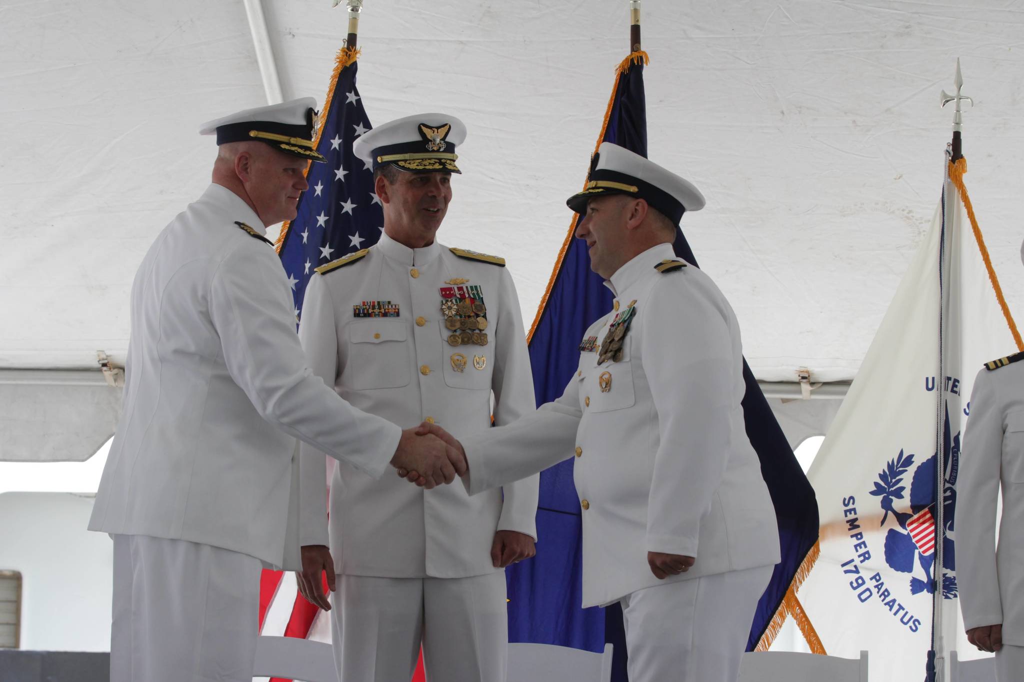 Capt. Darwin R. Jensen, left, takes command of Coast Guard Sector Juneau from Capt. Stephen J. White, right, in a change of command ceremony at the station on July 7, 2021. (Michael S. Lockett / Juneau Empire)