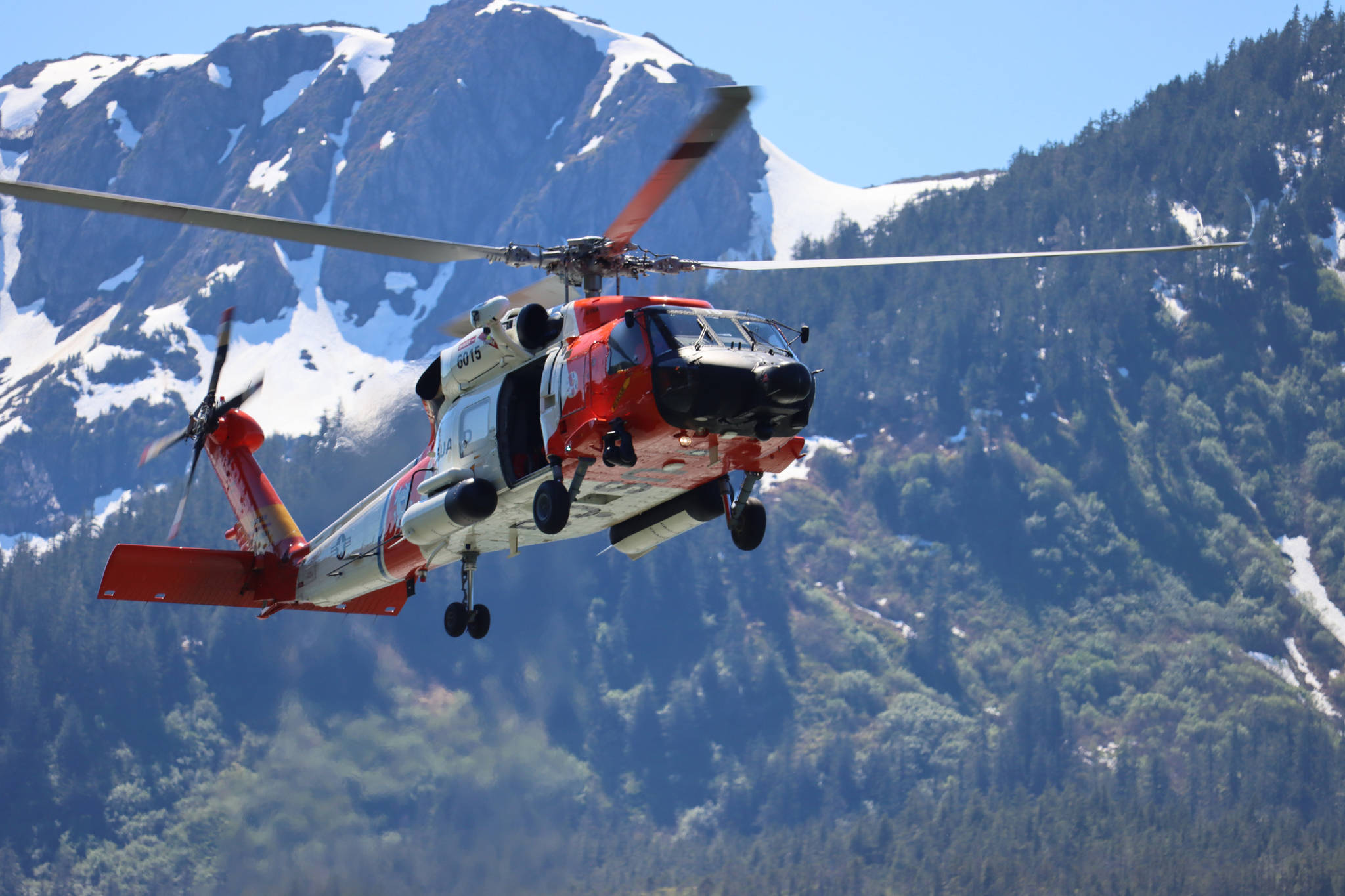 A Coast Guard helicopter demonstrates a water rescue during Juneau’s Maritime Festival. The Coast Guard is investigating a series of three vessels sinking across Southeast Alaska within an approximately twelve-hour period in late June. (Ben Hohenstatt / Juneau Empire File)