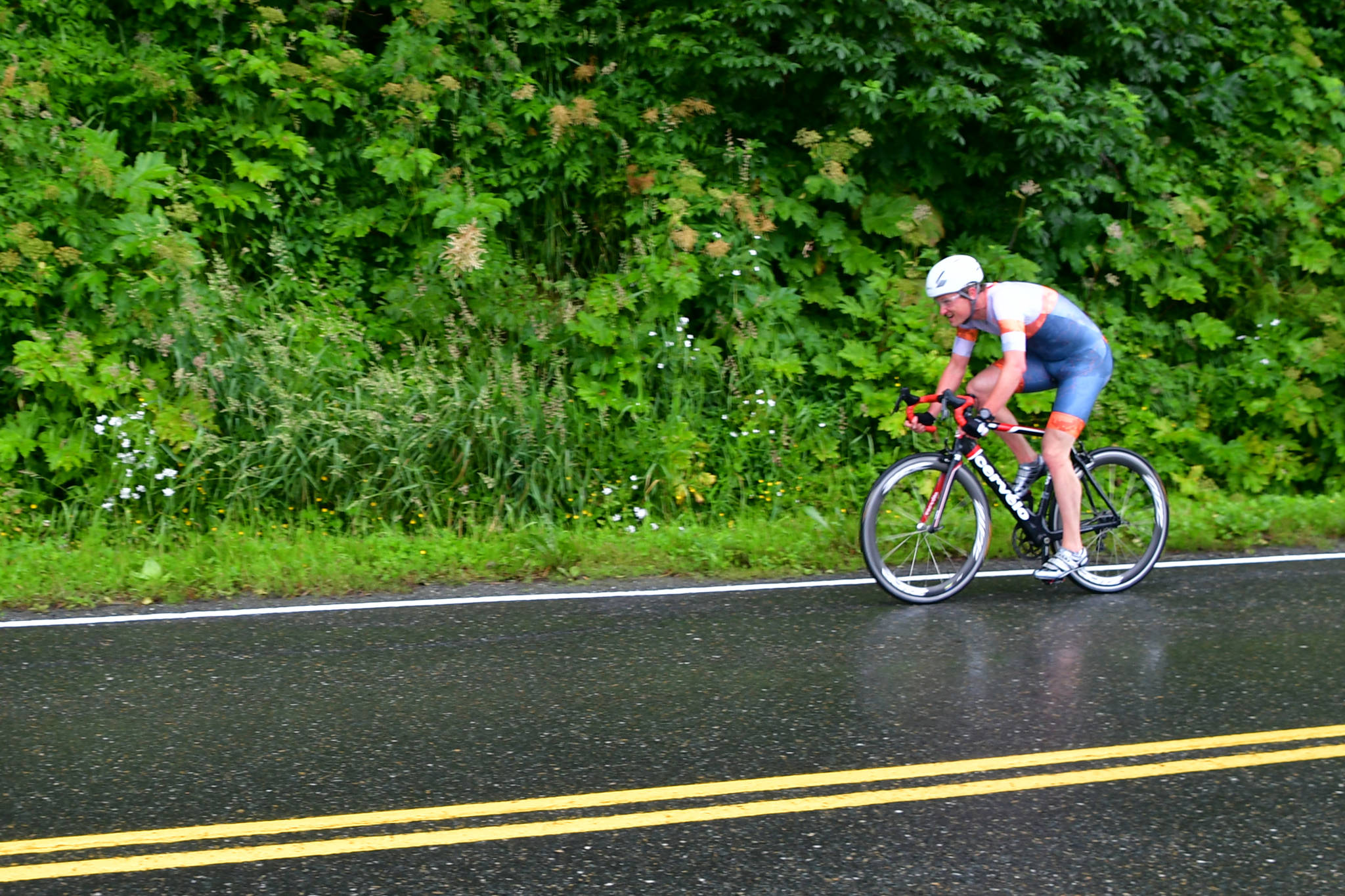 Justin Dorn pedals through the finish of Thane Road Donut Time Trial. Dorn claimed the top spot in the bicycle race that weights results based on the number of doughnuts each rider eats. Dorn finished with a doughnut-adjusted time of 21 minutes and 22 seconds by virtue of eating five doughnuts. (Courtesy Photo / Rob Welton)