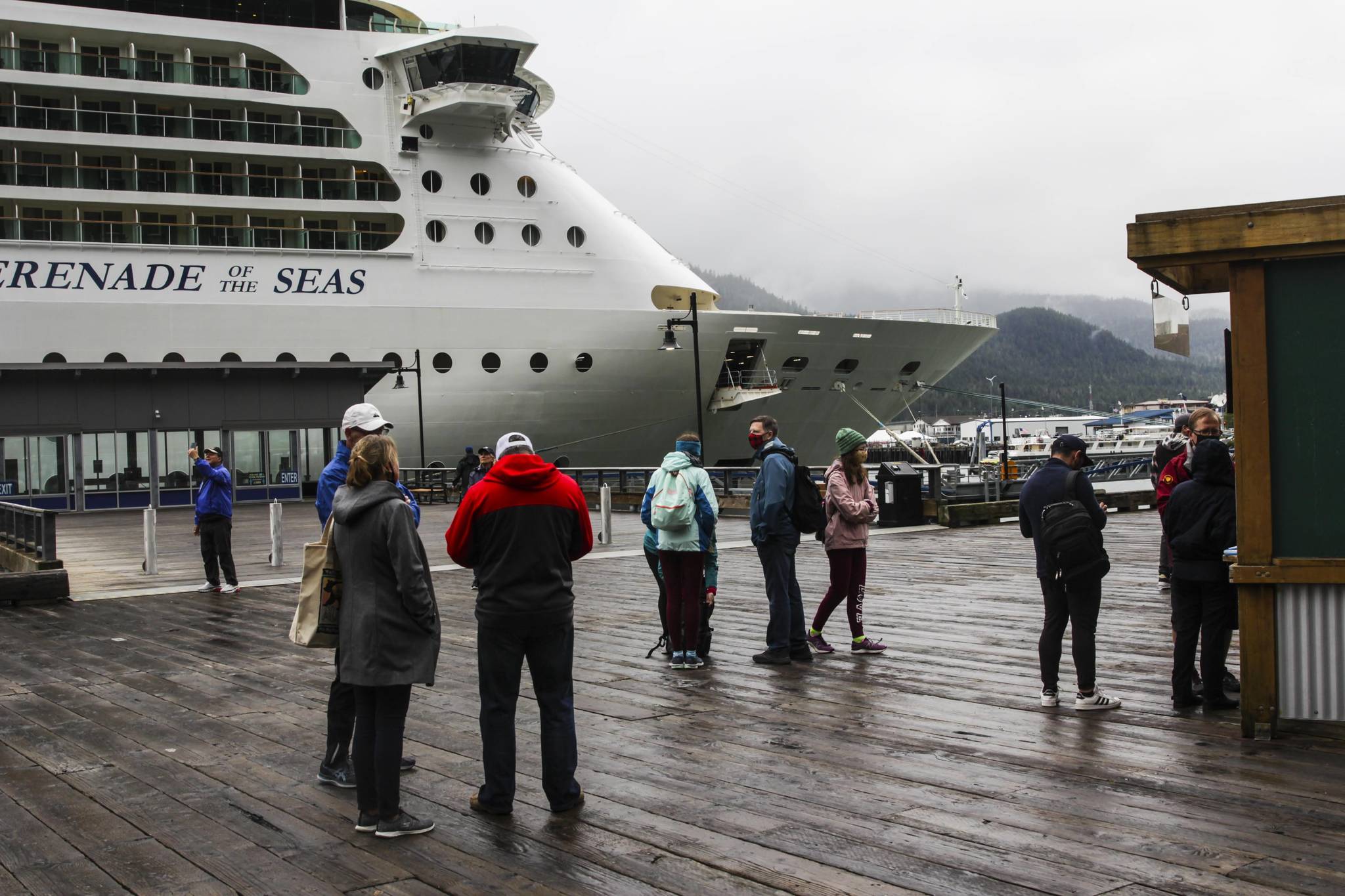 Tourists mill near the Serenade of the Seas, the first large cruise ship to come to Juneau in 2021, on Friday, July 23. (Michael S. Lockett / Juneau Empire)