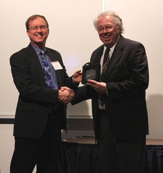 Neal Brown accepts the Roger Smith Lifetime Achievement award in 2016 from Geophysical Institute director Bob McCoy.(Courtesy Photo/ Geophysical Institute)