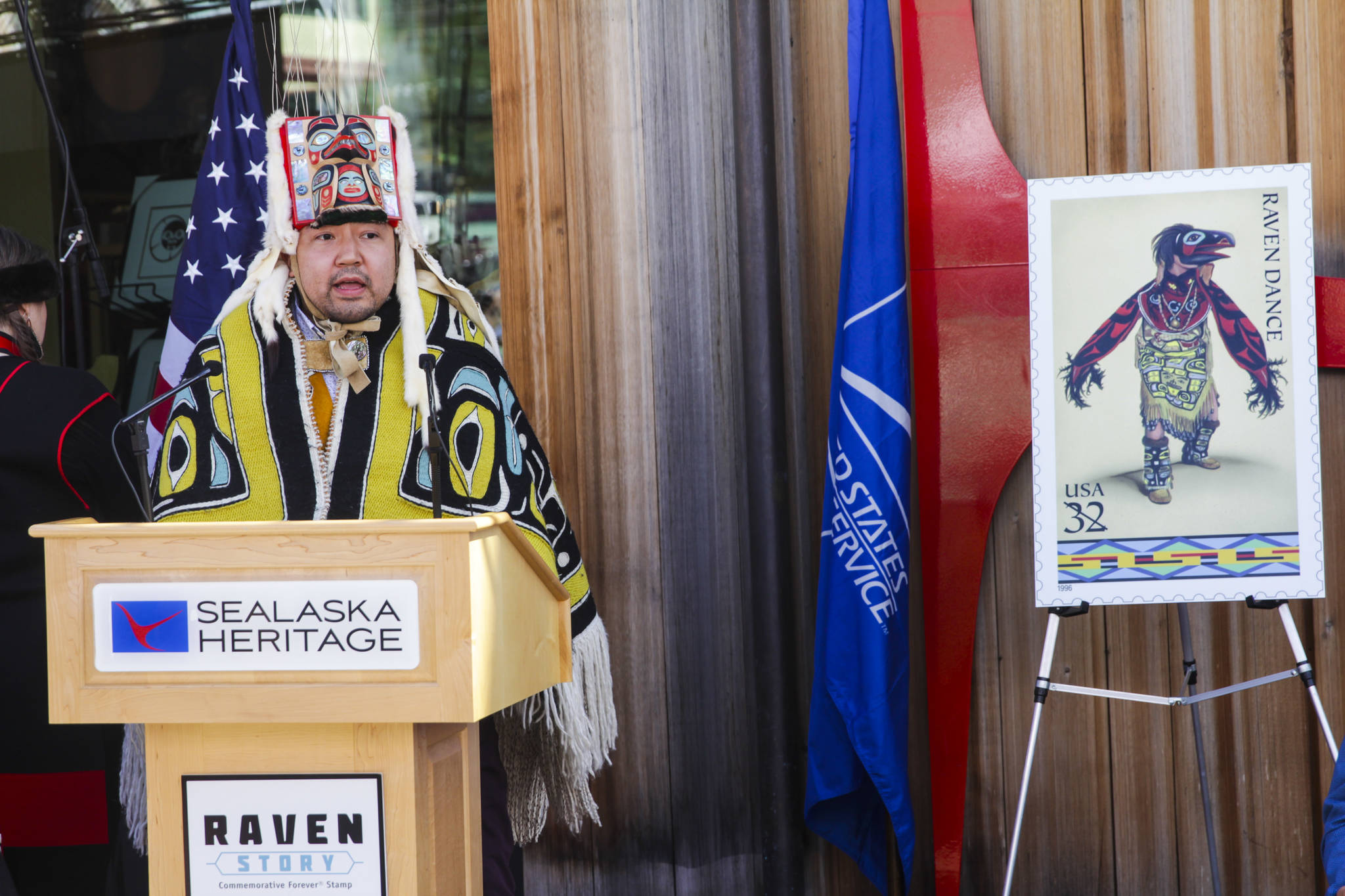 Rico Lanáat’ Worl, artist of the Raven Story stamp, which is according to SHI the first Tlingit design featured on a stamp, speaks to the crowd at the official release ceremony in front of the Sealaska Heritage Institute’s Walter Soboleff Building on Friday, July 30, 2021. (Michael S. Lockett / Juneau Empire)