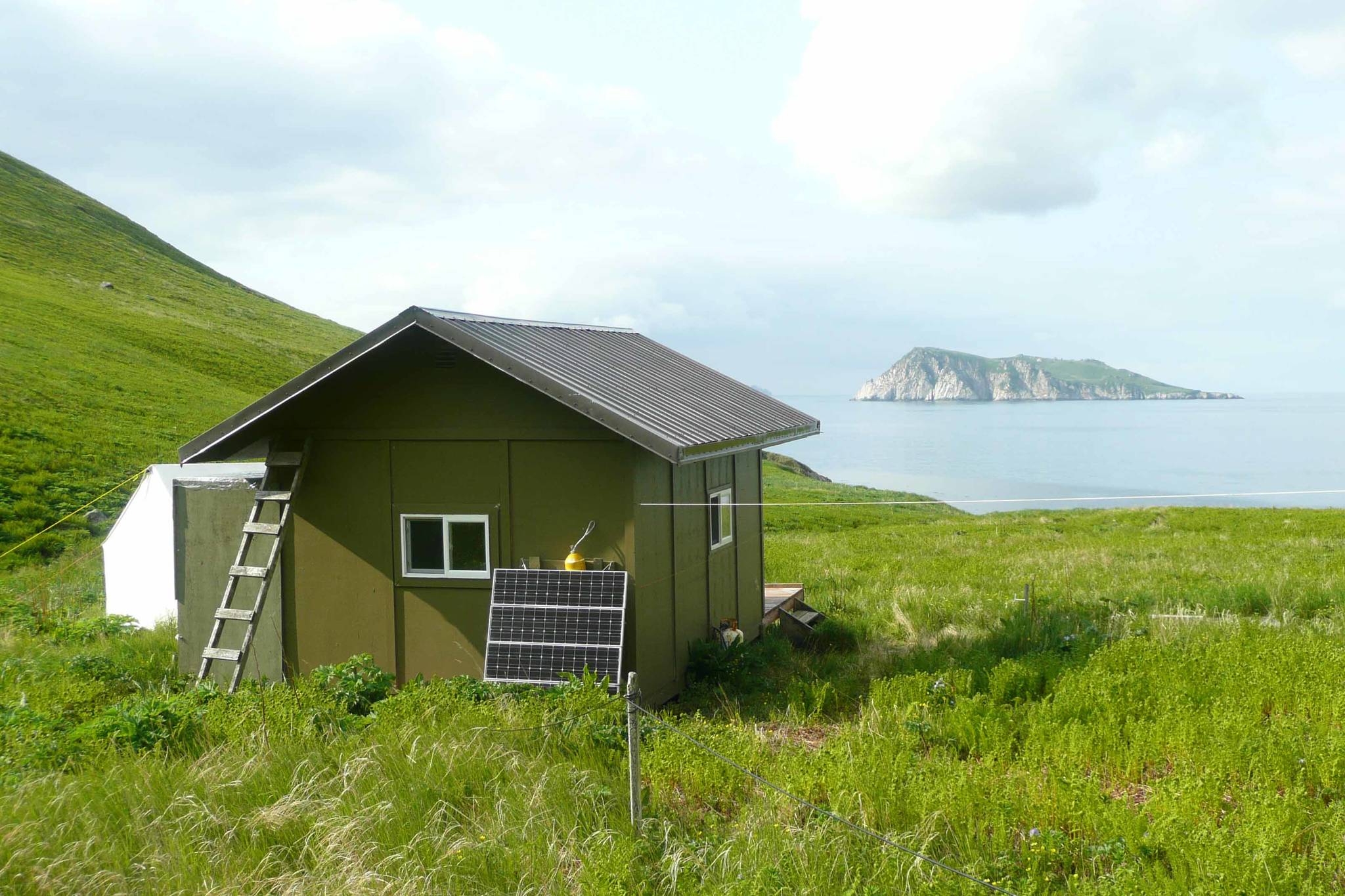A cabin on Chowiet Island off the Alaska Peninsula in which two biologists were the closest humans to a recent magnitude 8.2 earthquake. (Courtesy Photo /Erik Andersen, U.S. Fish and Wildlife Service.)