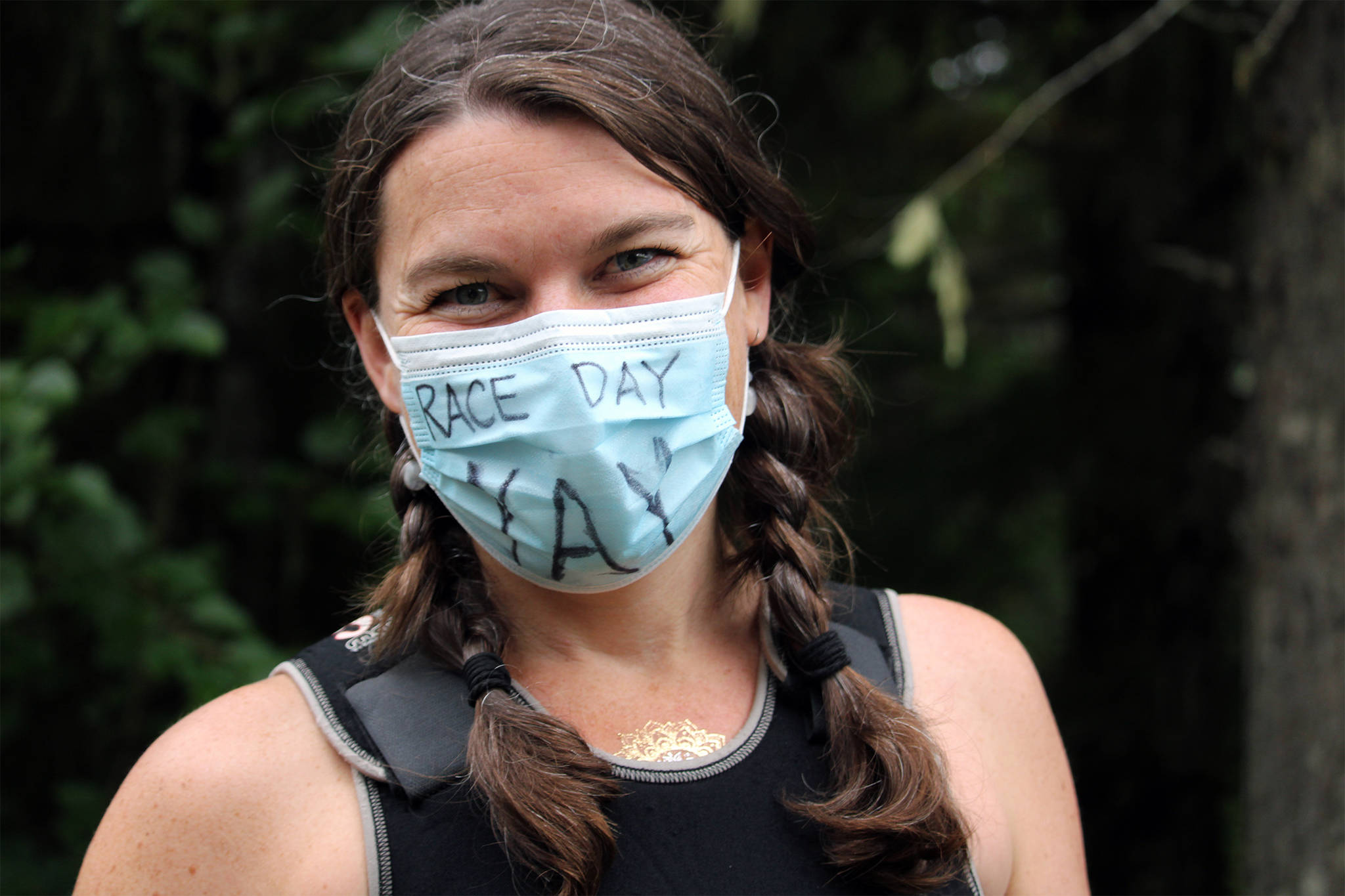 Juneau resident Katie Kowalchuk let her mask express her excitement before competing in the Aukeman Triathlon on Saturday, August 7. Organizers adopted COVID mitigations, including pre-race masking and distancing, as part of the event. (Dana Zigmund/Juneau Empire)
