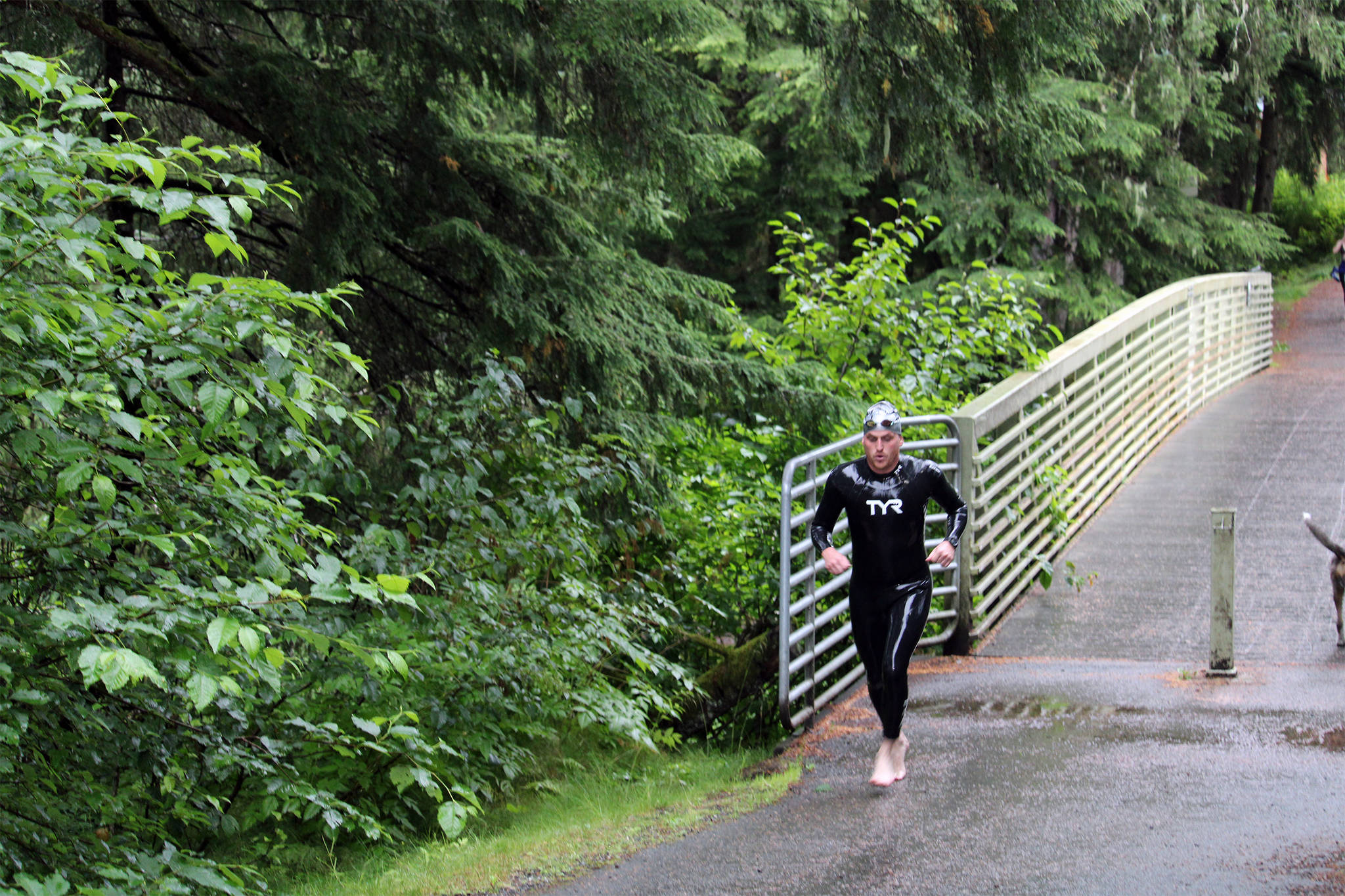 After completing the swim in Auke Lake, a triathlete runs to the bike staging area near the Mourant building to begin the cycling portion of the Aukeman Triathlon, which consisted of an out and back to the Mendenhall Glacier. (Dana Zigmund/Juneau Empire)