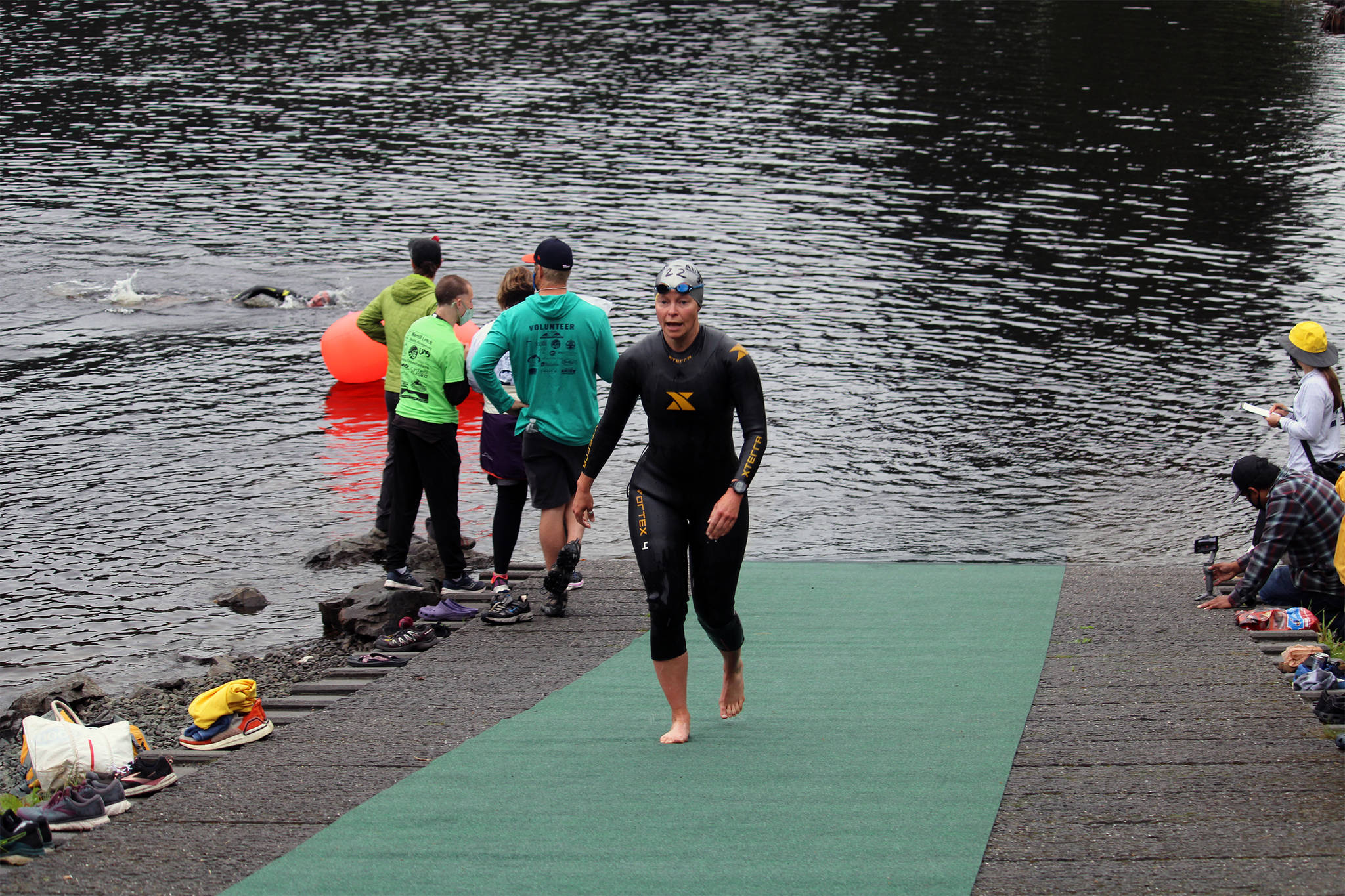 A swimmer emerges from Auke Lake as part of the Aukeman Triathlon on Saturday, August 7. (Dana Zigmund/Juneau Empire)
