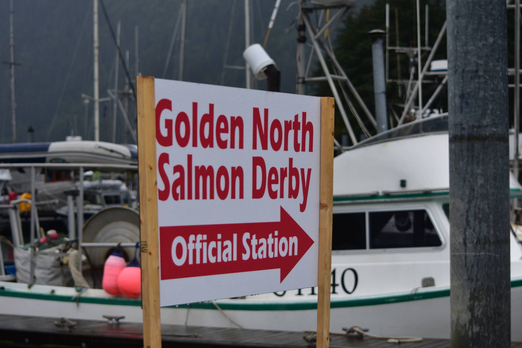 A sign points the way to the weigh station at the Mike Pusich Douglas Harbor during last year’s Golden North Salmon Derby on Aug. 16, 2020. This year is the derby’s 75th year and organizers have added additional prizes in celebration of the event. (Peter Segall / Juneau Empire)
