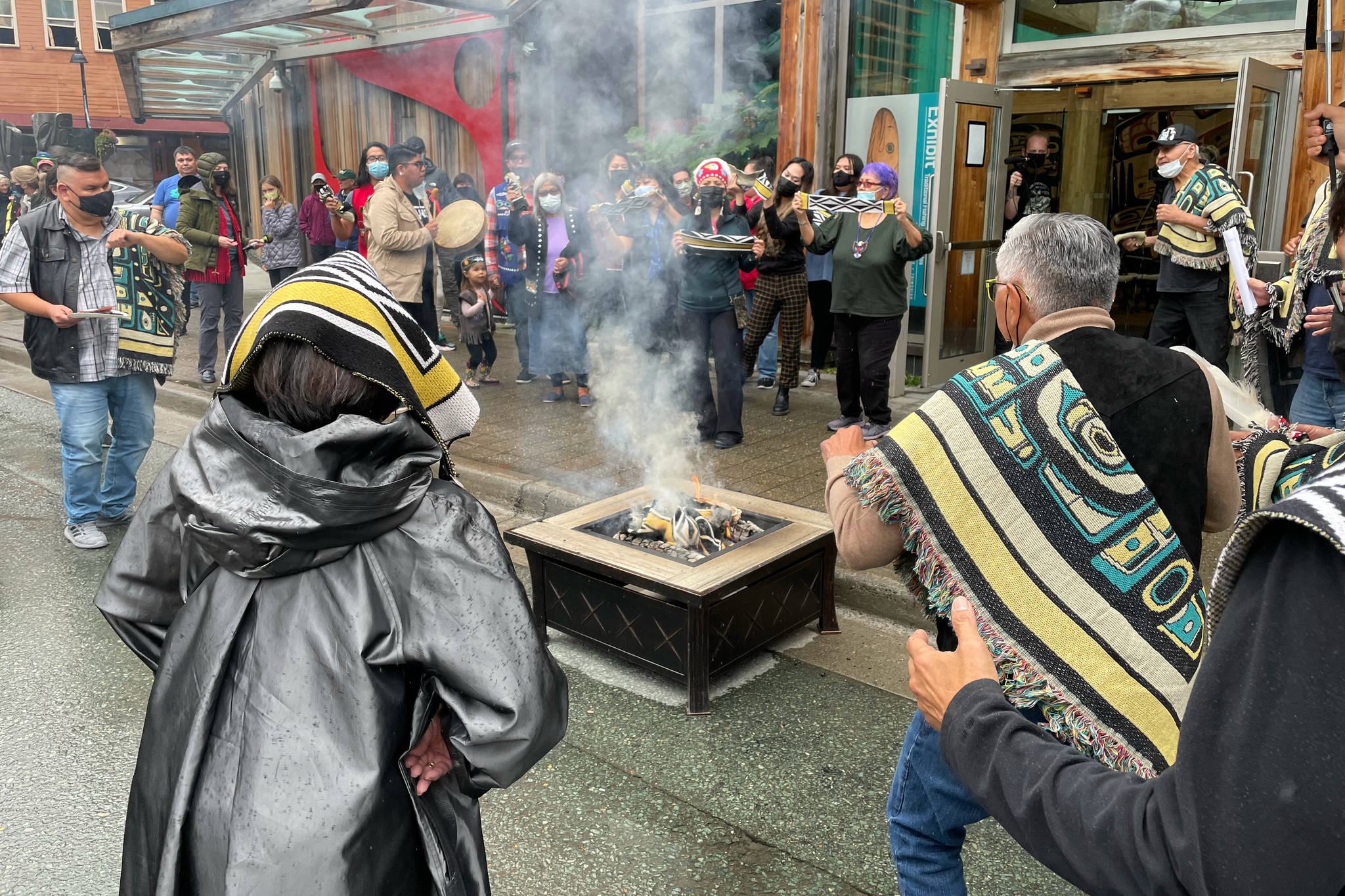 Michael S. Lockett / Juneau Empire 
Participants burn an example of a commercial garment that led to a now-settled intellectual property lawsuit in a ceremony commemorating the settlement with the fashion company on Friday, Aug. 13, 2021.