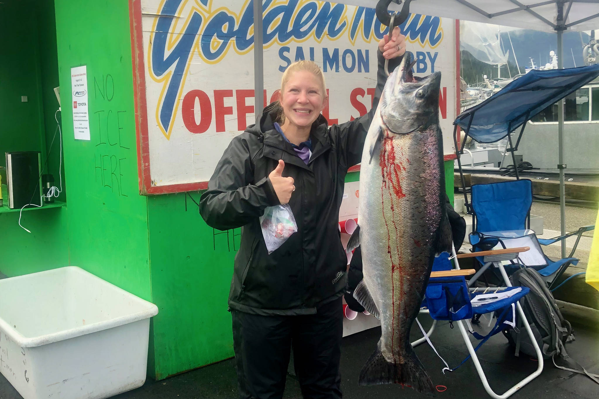 Tiffany Listberger poses with her 31.7-pound king salmon turned in at the Auke Bay weight station on Sunday. According to provisional results, Listberger is the winner of the 75th annual Goldern North Salmon Derby. (Courtesy photo / Derek Listeberger)