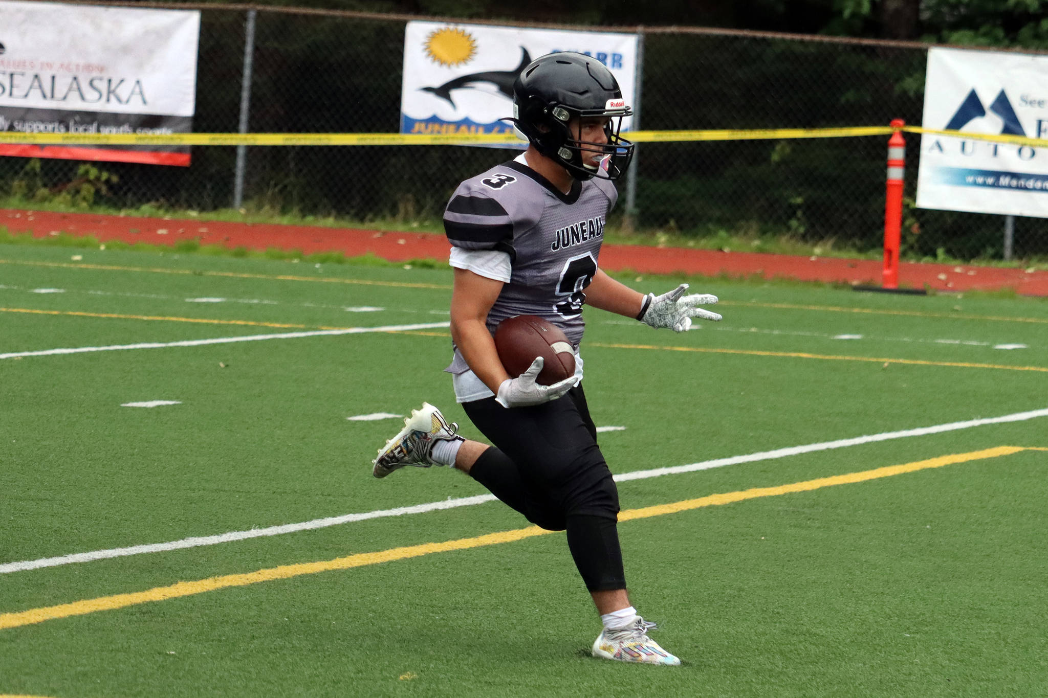 Gaby Soto crosses the goal line to put six points on the board for the Huskies in Juneau’s first high school football game in nearly two years. Soto scored three touchdowns for the Huskies in the first half. (Ben Hohenstatt / Juneau Empire)