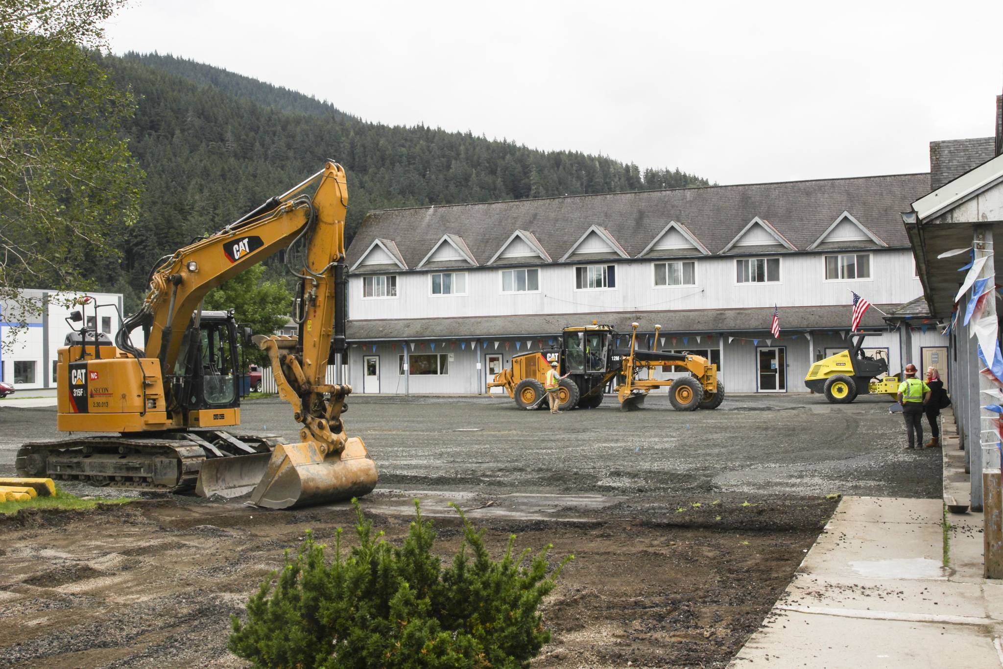 Contractors from SECON replace the parking of St. Vincent de Paul Juneau on Aug. 20, 2021. (Michael S. Lockett / Juneau Empire)
