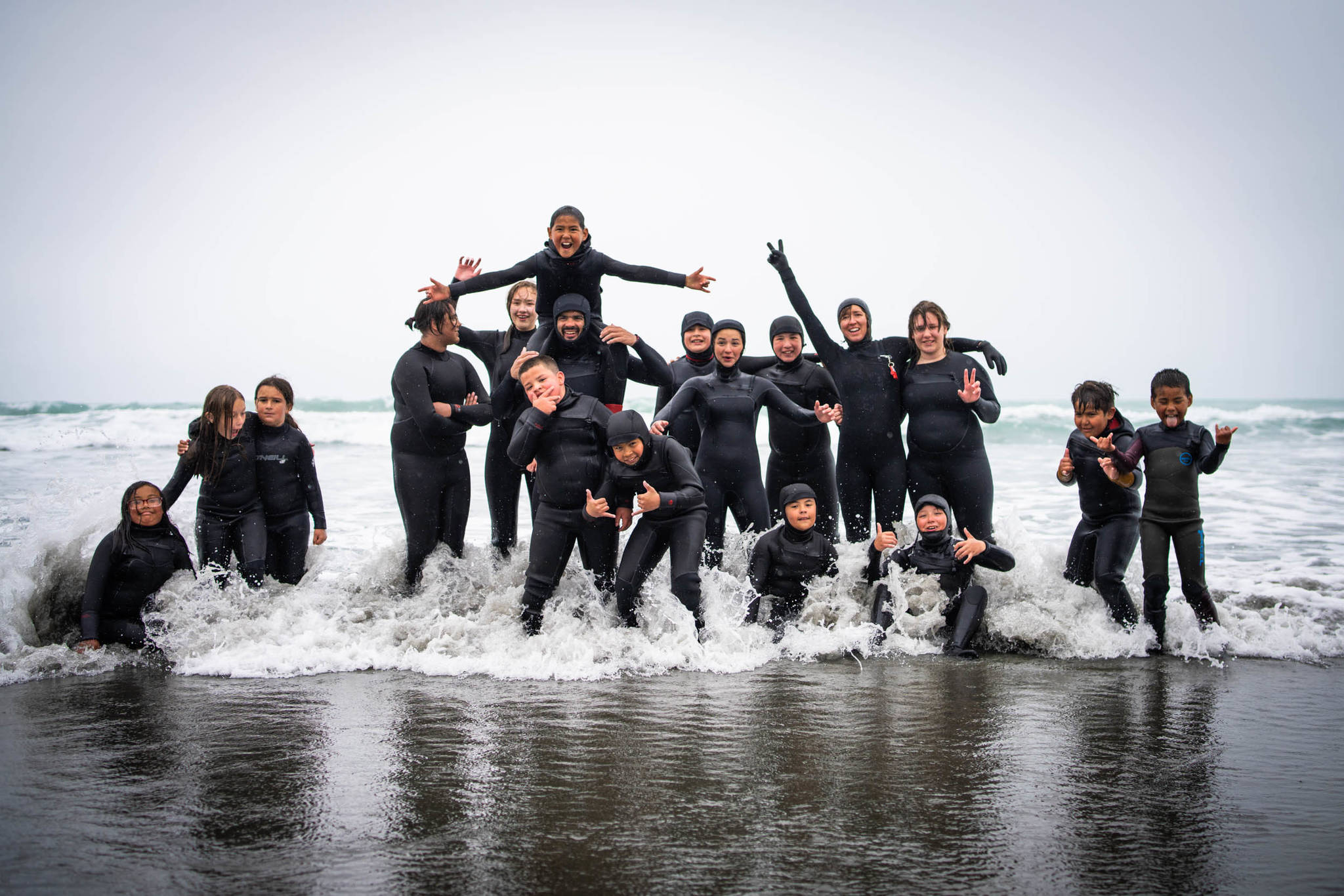 Yakutat Surf Club creates community and allows youth of all ages to forge strong friendships while encouraging each other in the break. Participants pose with coaches Chelsea Jolly and Ryan Cortes. (Courtesy Photo / Bethany Sonsini Goodrich)