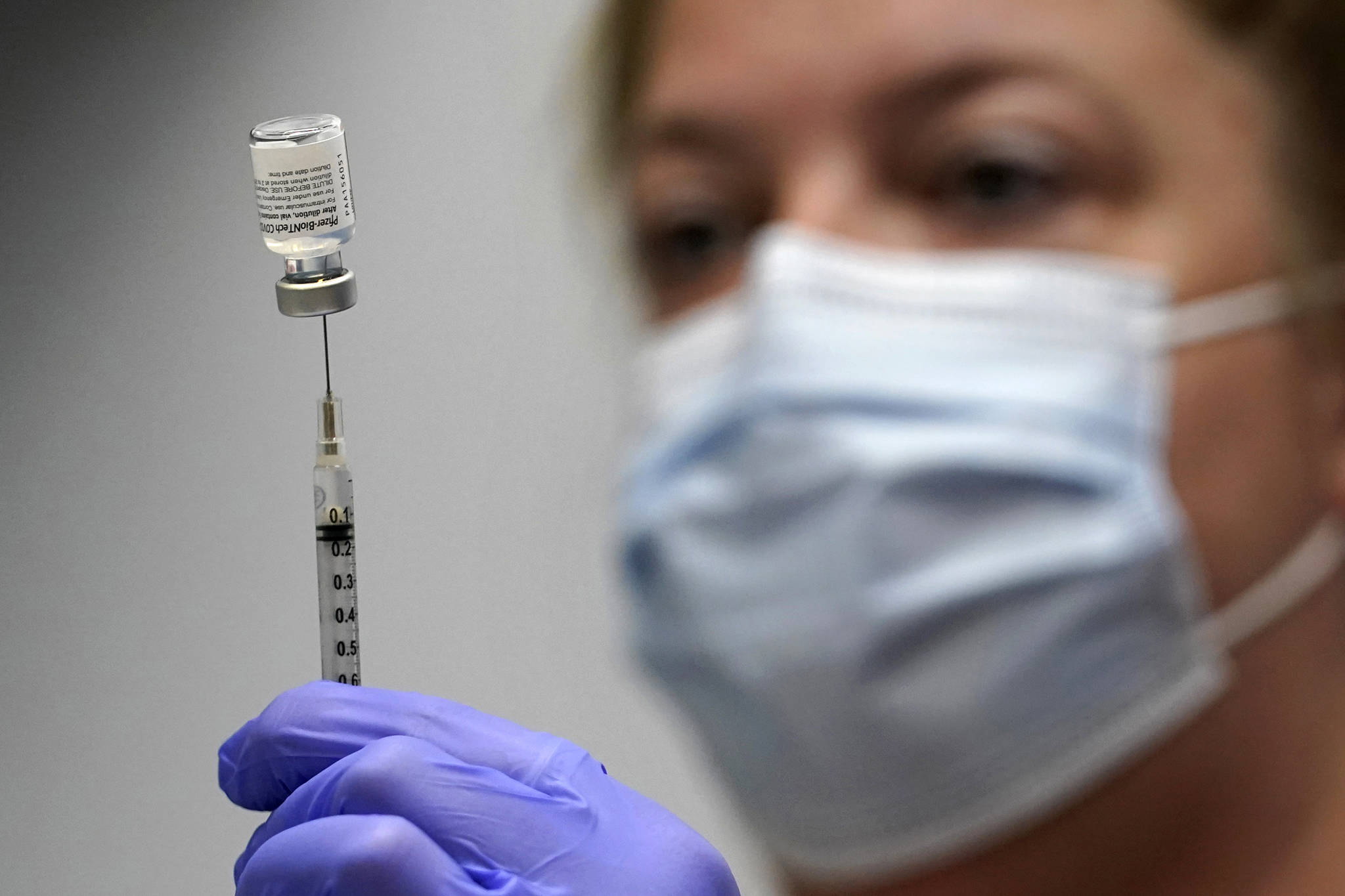 In this March 2, 2021, photo, pharmacy technician Hollie Maloney loads a syringe with Pfizers COVID-19 vaccine at the Portland Expo in Portland, Maine. The U.S. gave full approval to Pfizers COVID-19 vaccine on Monday, Aug. 23, 2021. (AP Photo / Robert F. Bukaty)