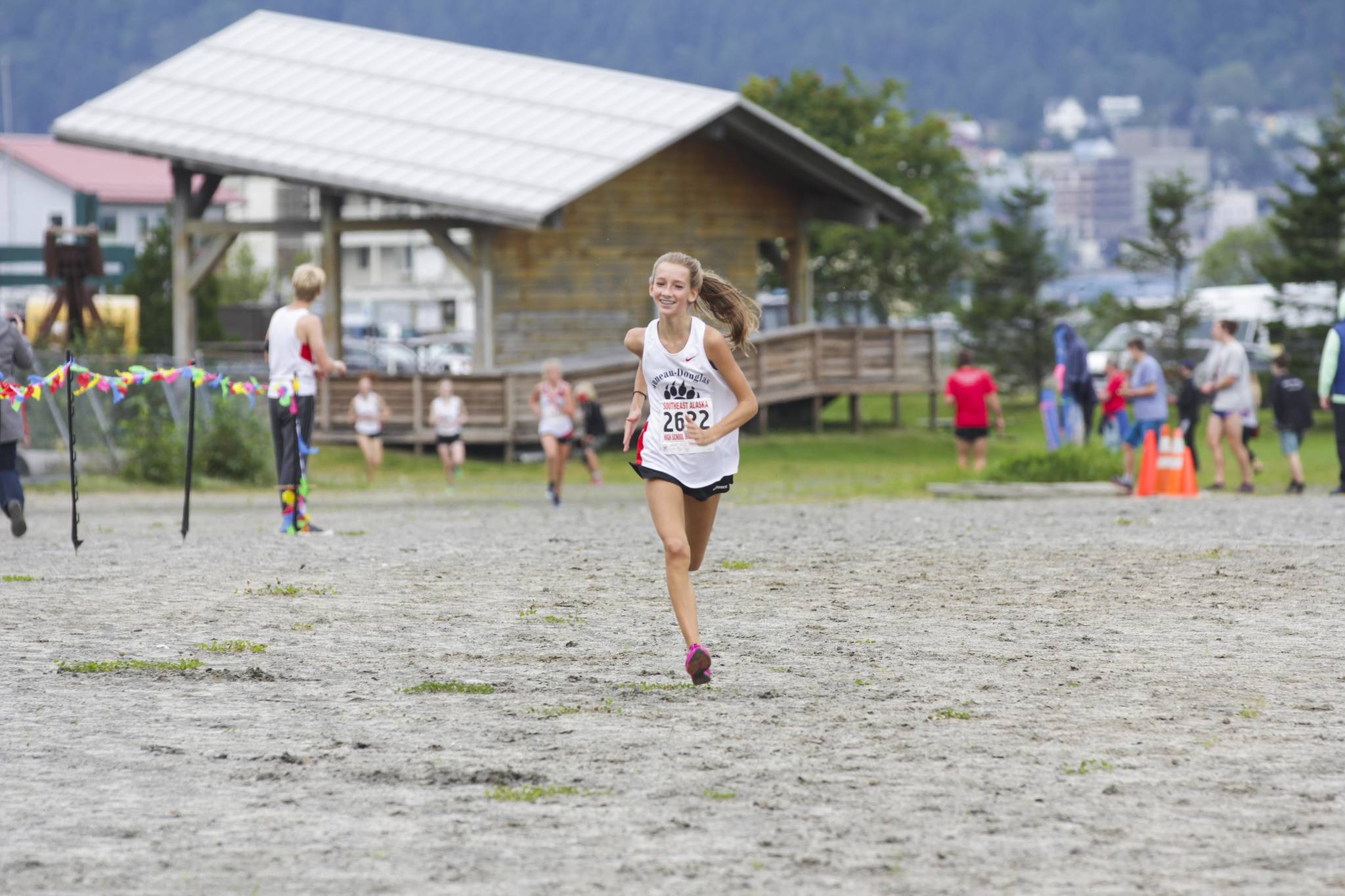 Rayna Tuckwood, Juneau-Douglas High School: Yadaa.at Kalé sophomore, sprints to the finish during a cross country race at Savikko Park on Saturday, Aug. 21, 2021. Tuckwood would place first with a time of 20:20 as the JDHS girls took the first five places. (Michael S. Lockett / Juneau Empire)