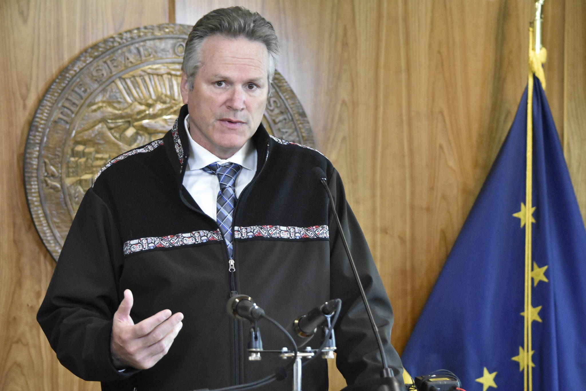 Gov. Mike Dunleavy, seen here at an Aug. 16, news conference, announced Thursday the state was taking steps to help Alaska’s hospitals deal with the strain of a spike in COVID-19 cases. (Peter Segall / Juneau Empire file)
