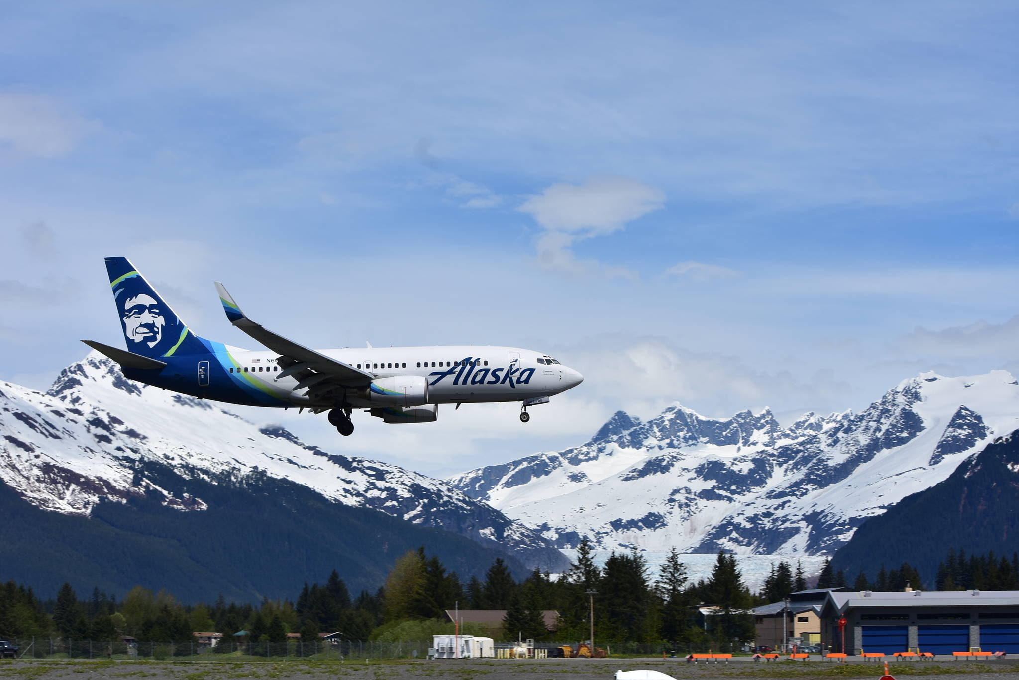 A plane lands at Juneau International Airport on May 25, 2021, as the number of travelers in the state started to rise after the lockdowns of 2020. Travel numbers are not back up to their pre-pandemic levels, but they are increasing according to local travel authorities. (Peter Segall / Juneau Empire file)