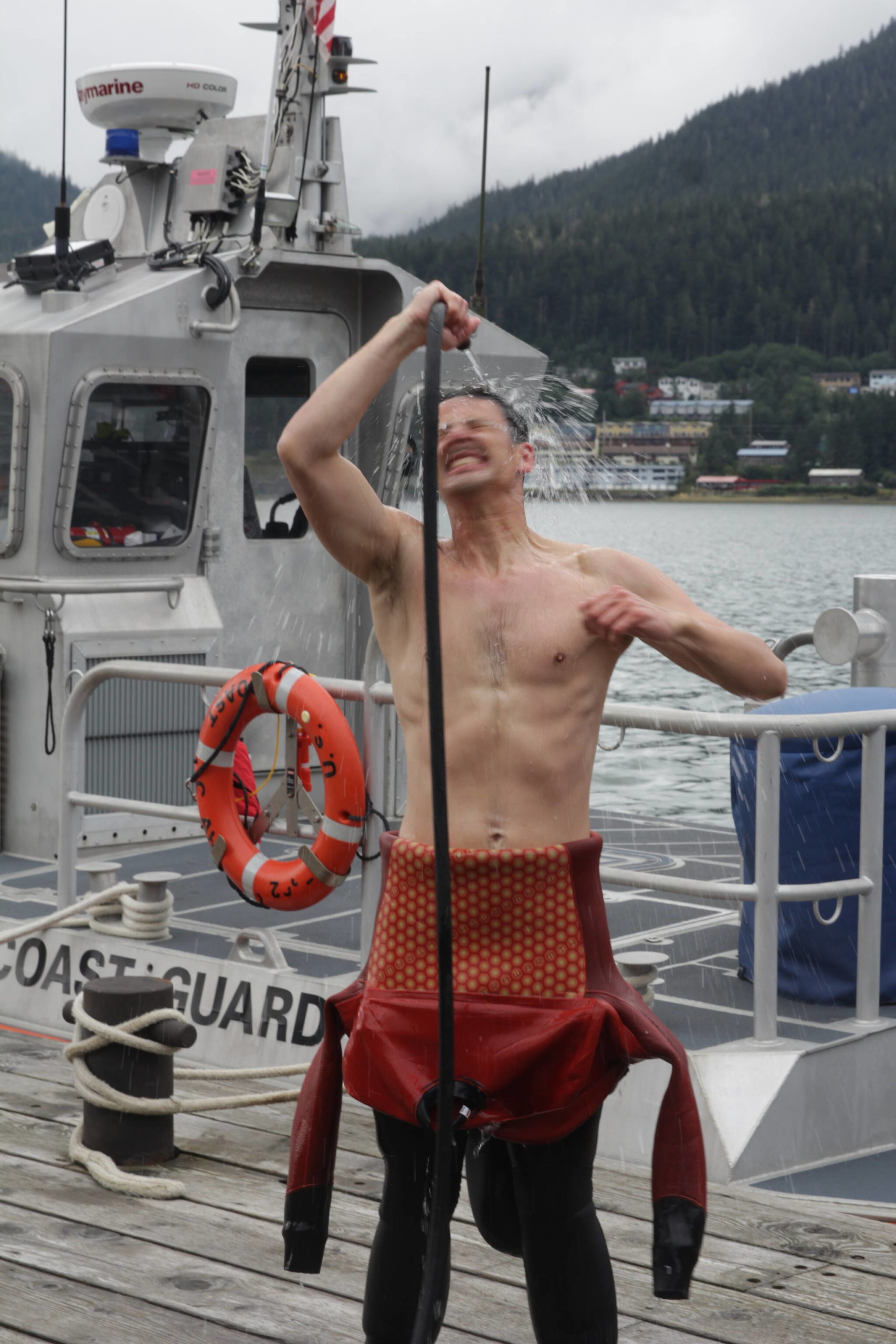 Army Pfc. Dylan Kloss rinses off after a dive in downtown Juneau as part of training for the engineer divers with a Coast Guard dive team on Sept. 6, 2021. (Courtesy photo / MyKenzie Robertson)